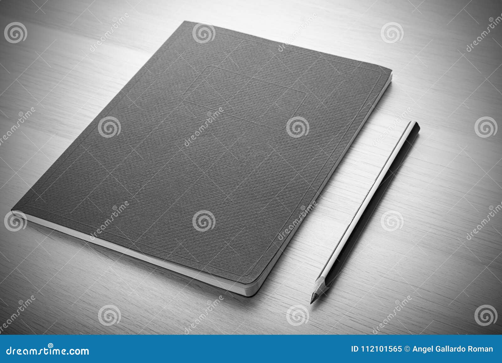 notepad on wooden desk with pencil