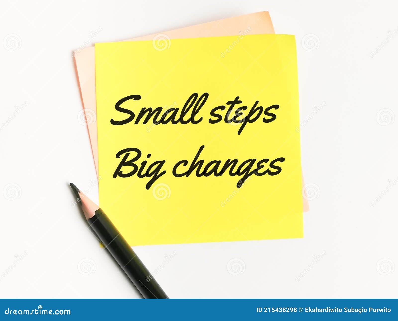 phrase small steps big changes written on sticky note with a pencil.