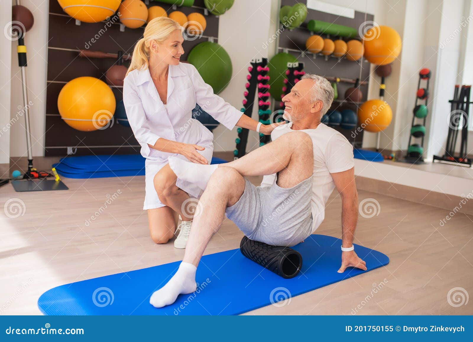 Physical Therapist in Lab Coat Working with Patient on His Junctions