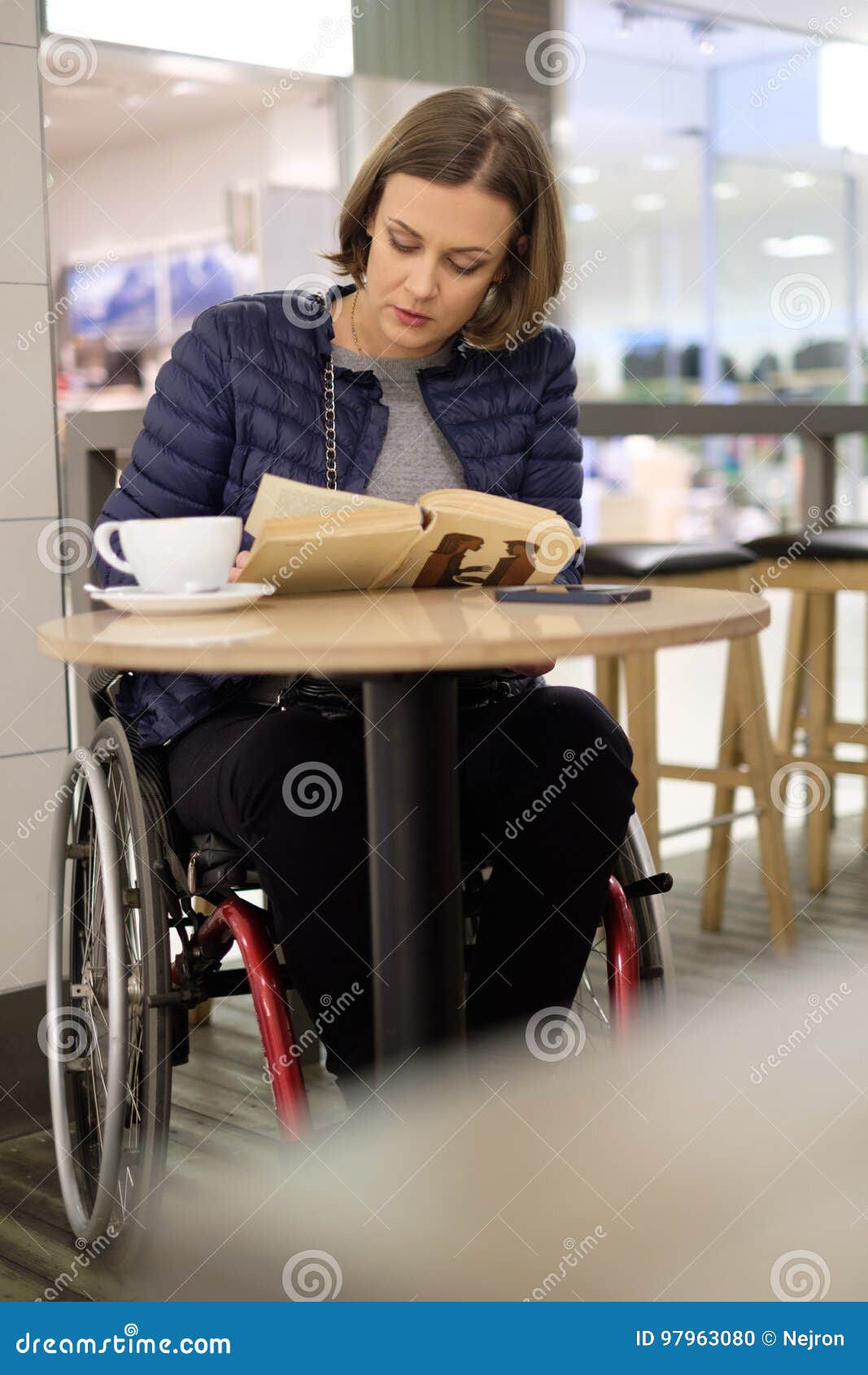 physically challenged woman reading in a cafe
