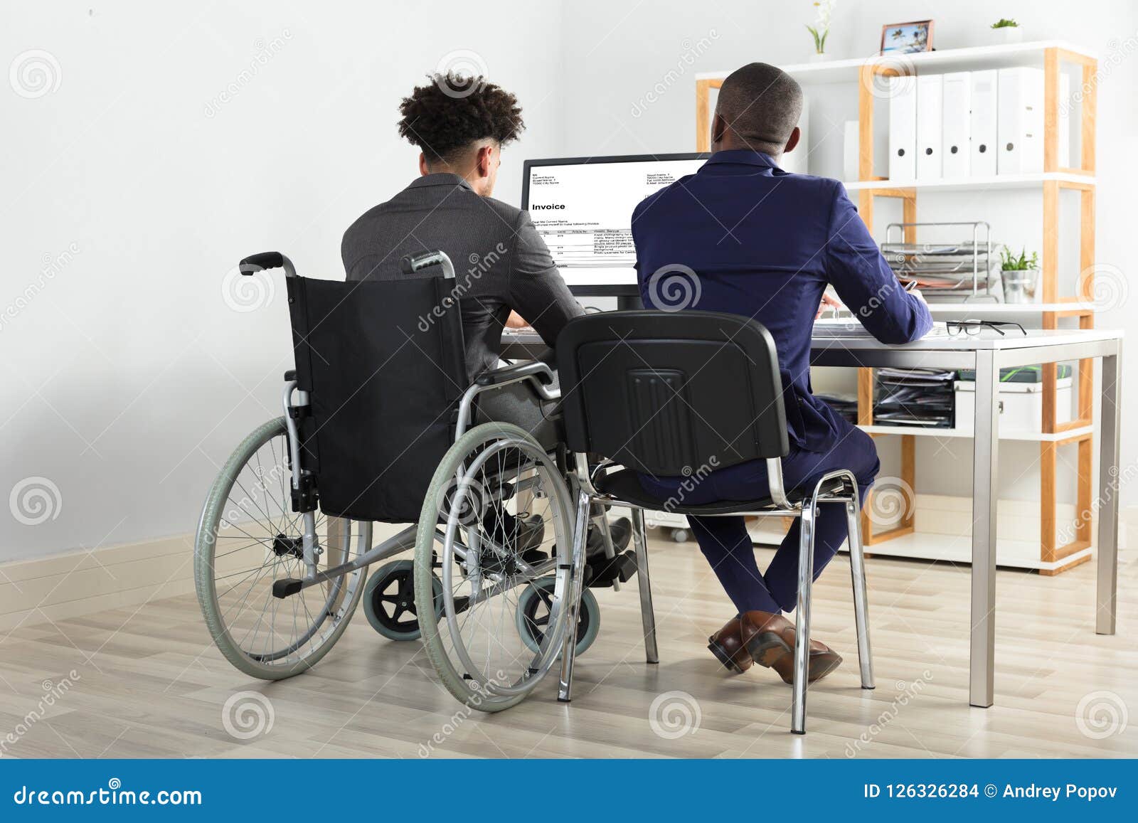 physically impaired businessman with his partner working