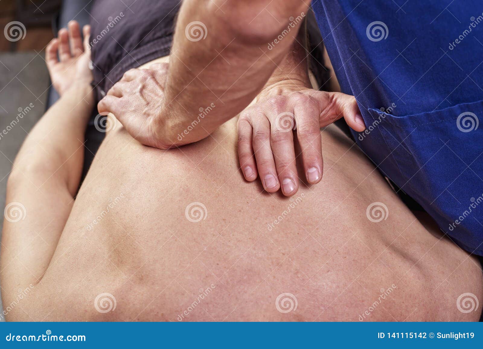physiotherapist giving a back massage. chiropractic, osteopathy, manual therapy, acupressure