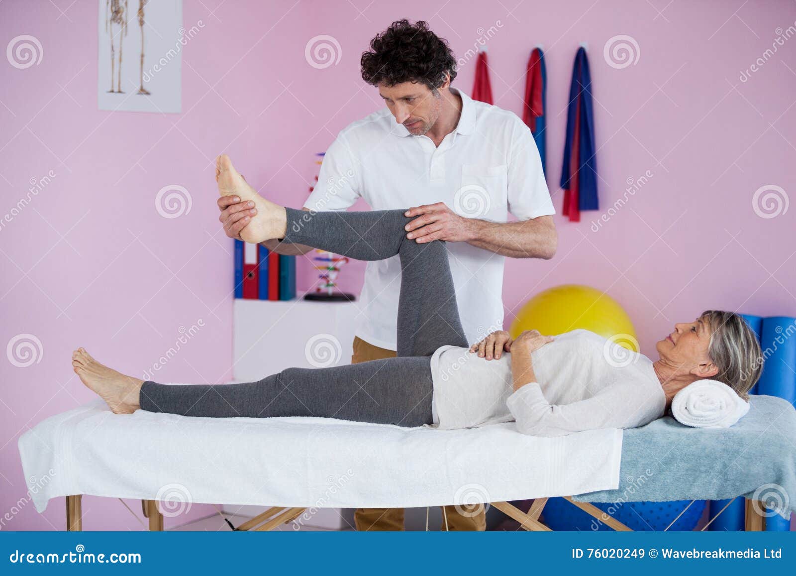 Physiotherapist Giving Leg Massage To A Senior Woman Stock Image