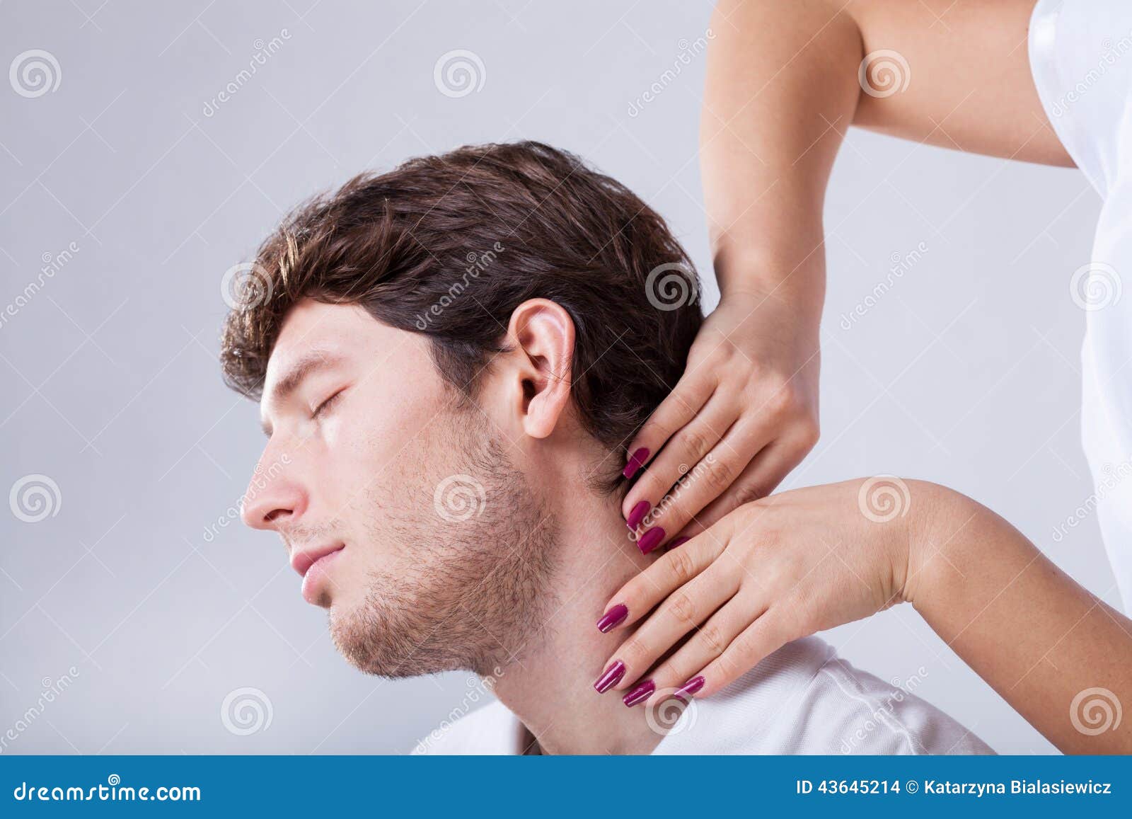 physiotherapist palpationing patient with stiff neck