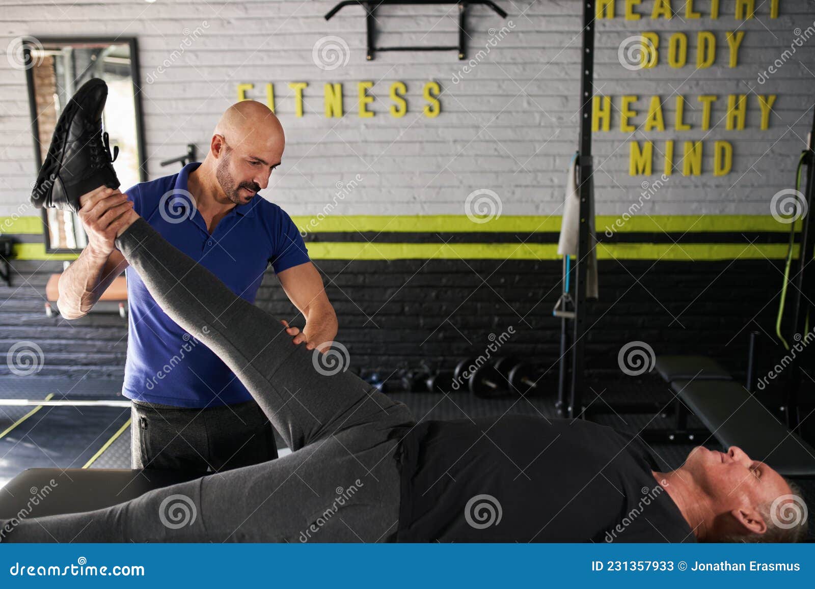 physiotherapist stretching mature, elderly man, strength rehabilitation