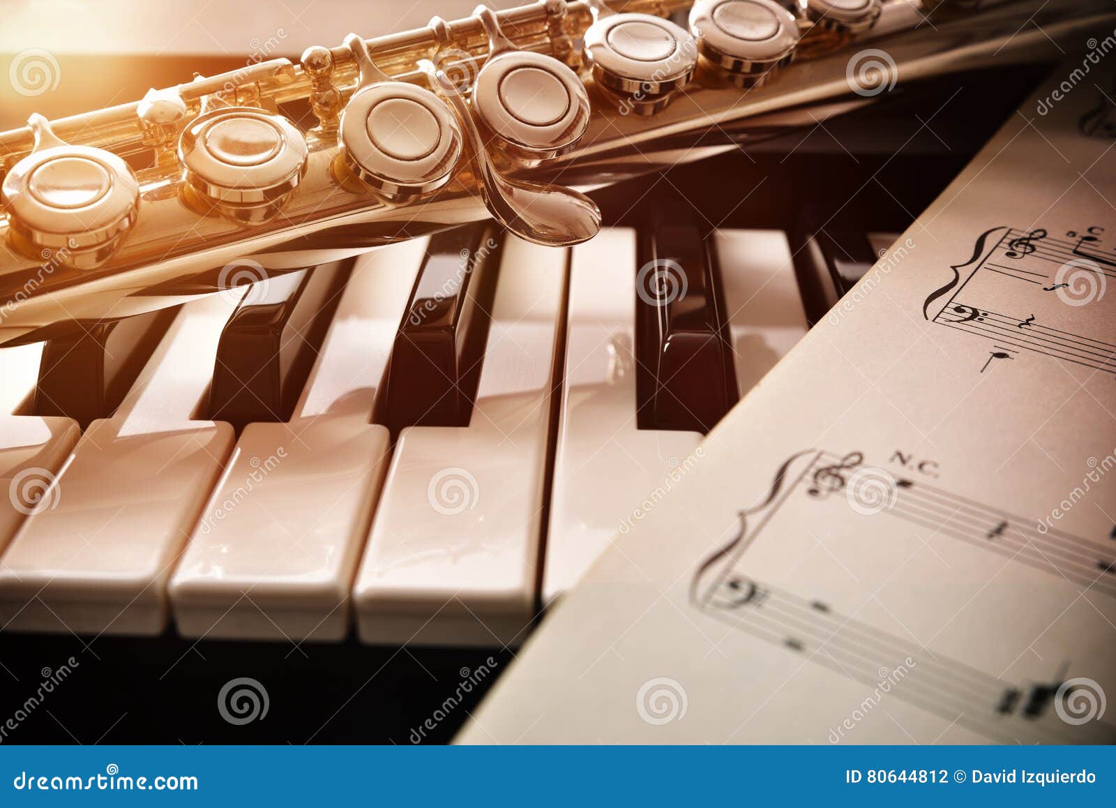 Piano and Flute with Golden Shine and Sheet Music Front Stock Photo