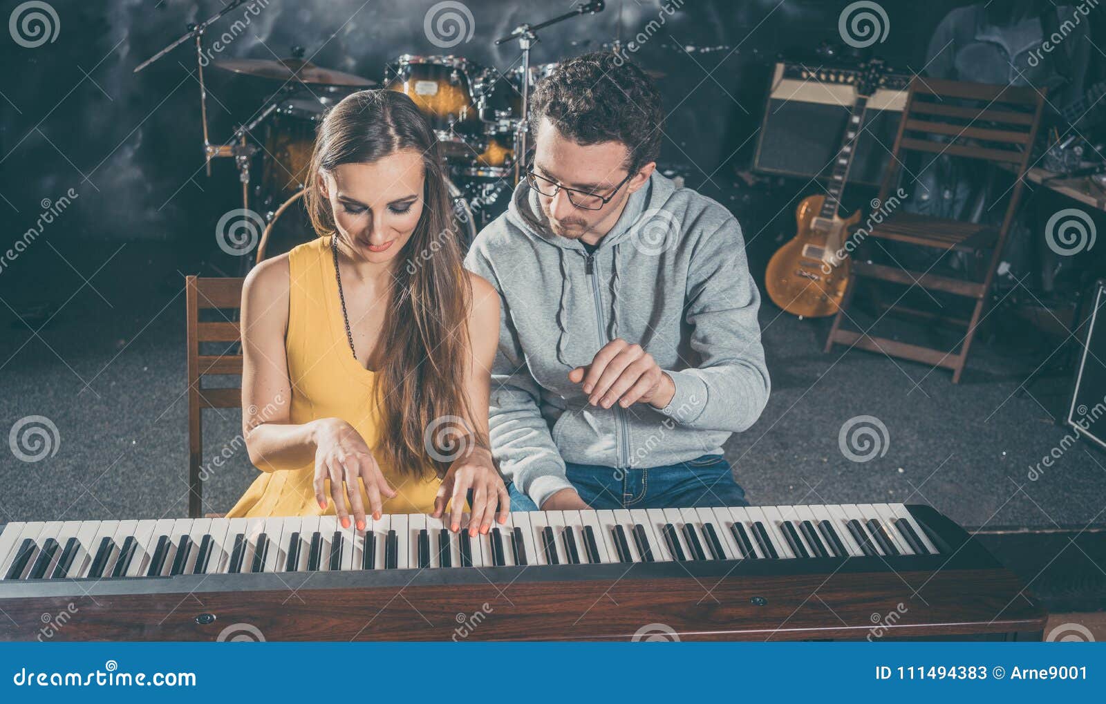Piano Teacher Giving Music Lessons To His Student Stock Image Image Of Adult Musician 111494383