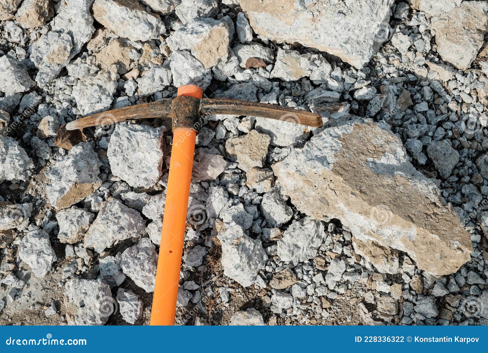 Pickaxe Hoe Lying on Crushed Stones. Handheld Percussion Tool Designed