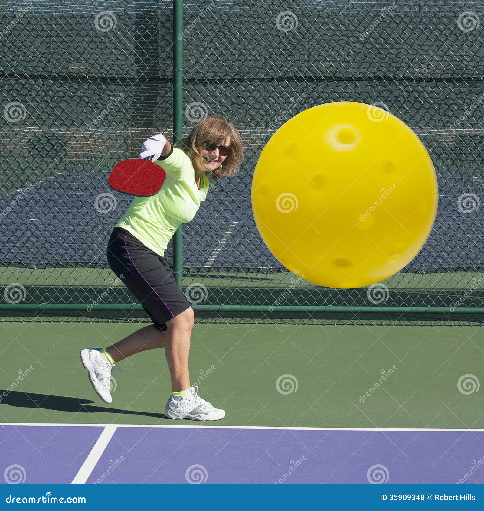 pickleball action - senior woman hitting backhand