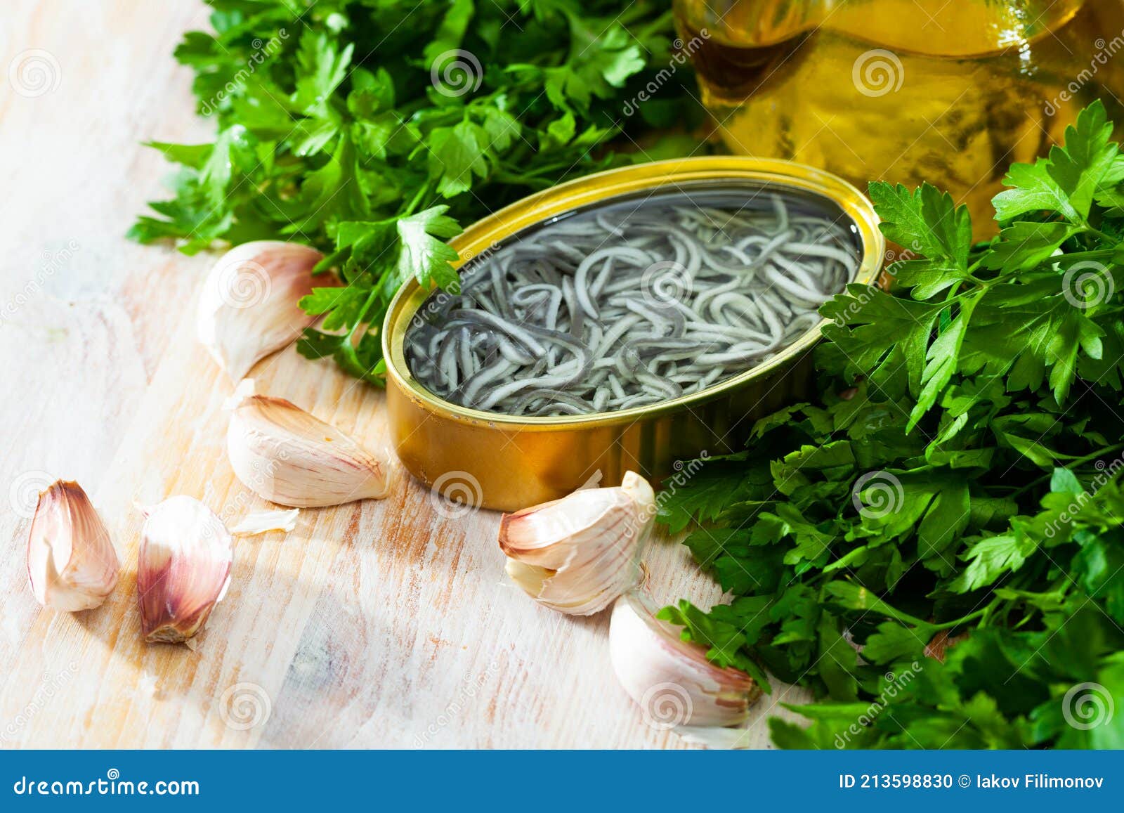 Pickled Eels in Open Tin Can with Garlic at Table Stock Photo Image