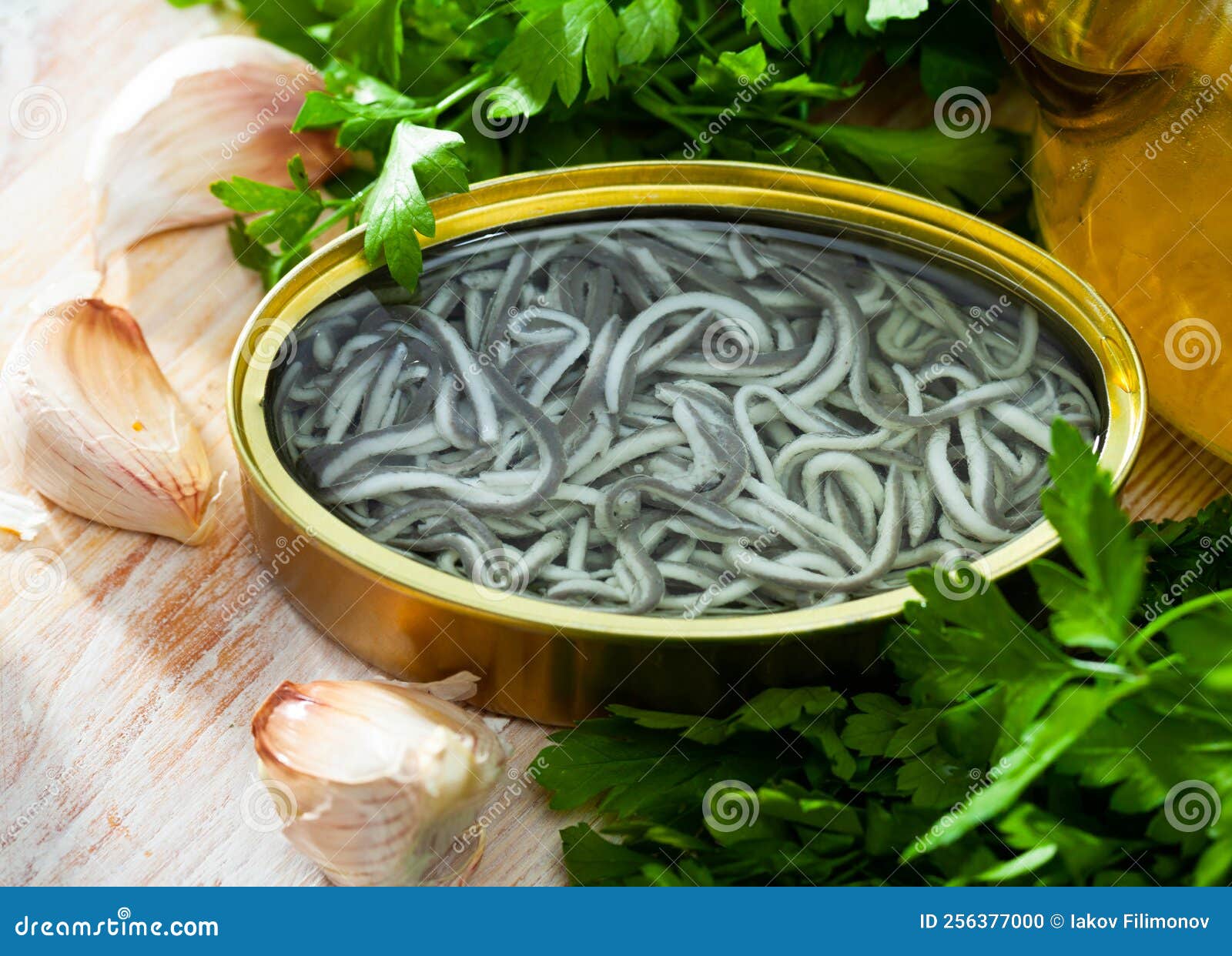 Pickled Eels in Open Tin Can with Garlic at Table Stock Photo Image of delicious, greens