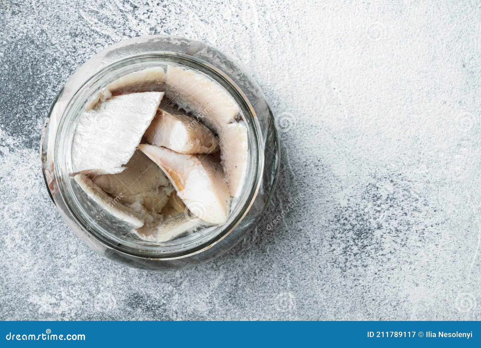 Pickled Herring, in Glass Jar, on Gray Background, Top View Flat Lay