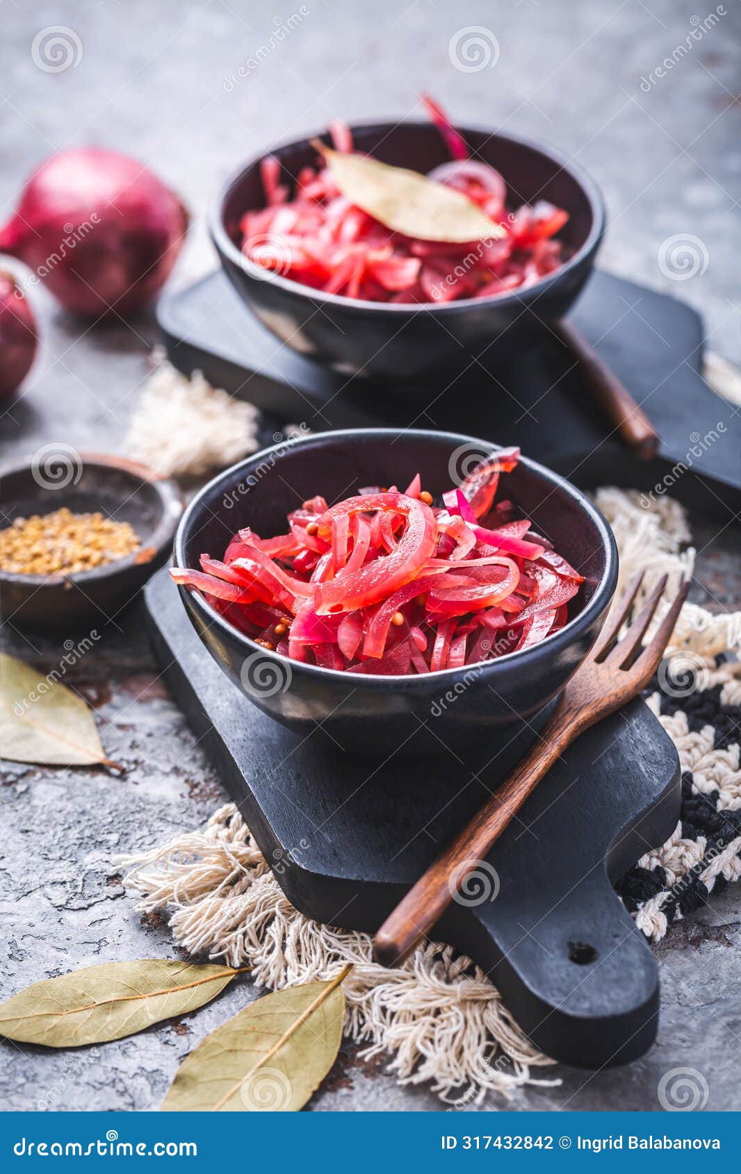 pickled red onions in bowl on a gray background. appetizer, condiment or topping, healthy fermented food