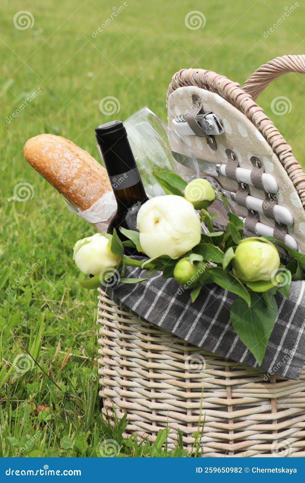 Picnic Basket with Wine, Bread and Flowers on Green Grass Outdoors Stock Photo Image of