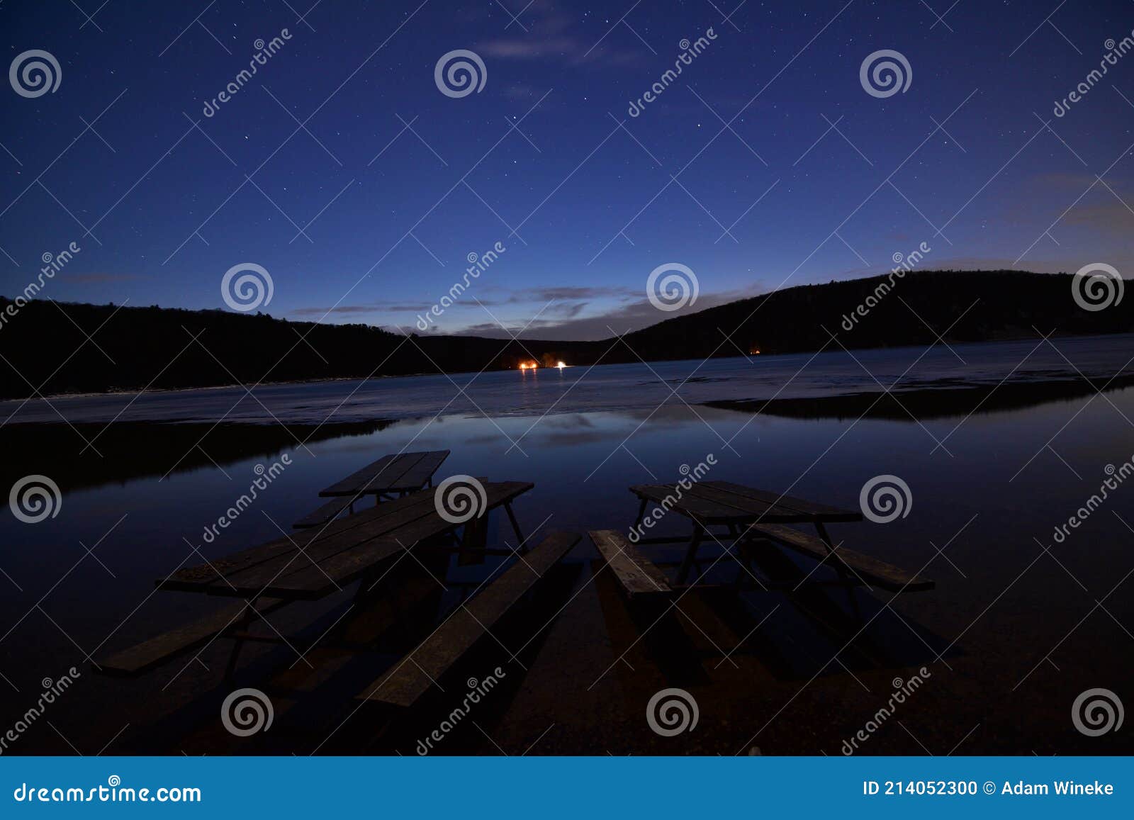 picnic tables in the partially frozen devils lake at night