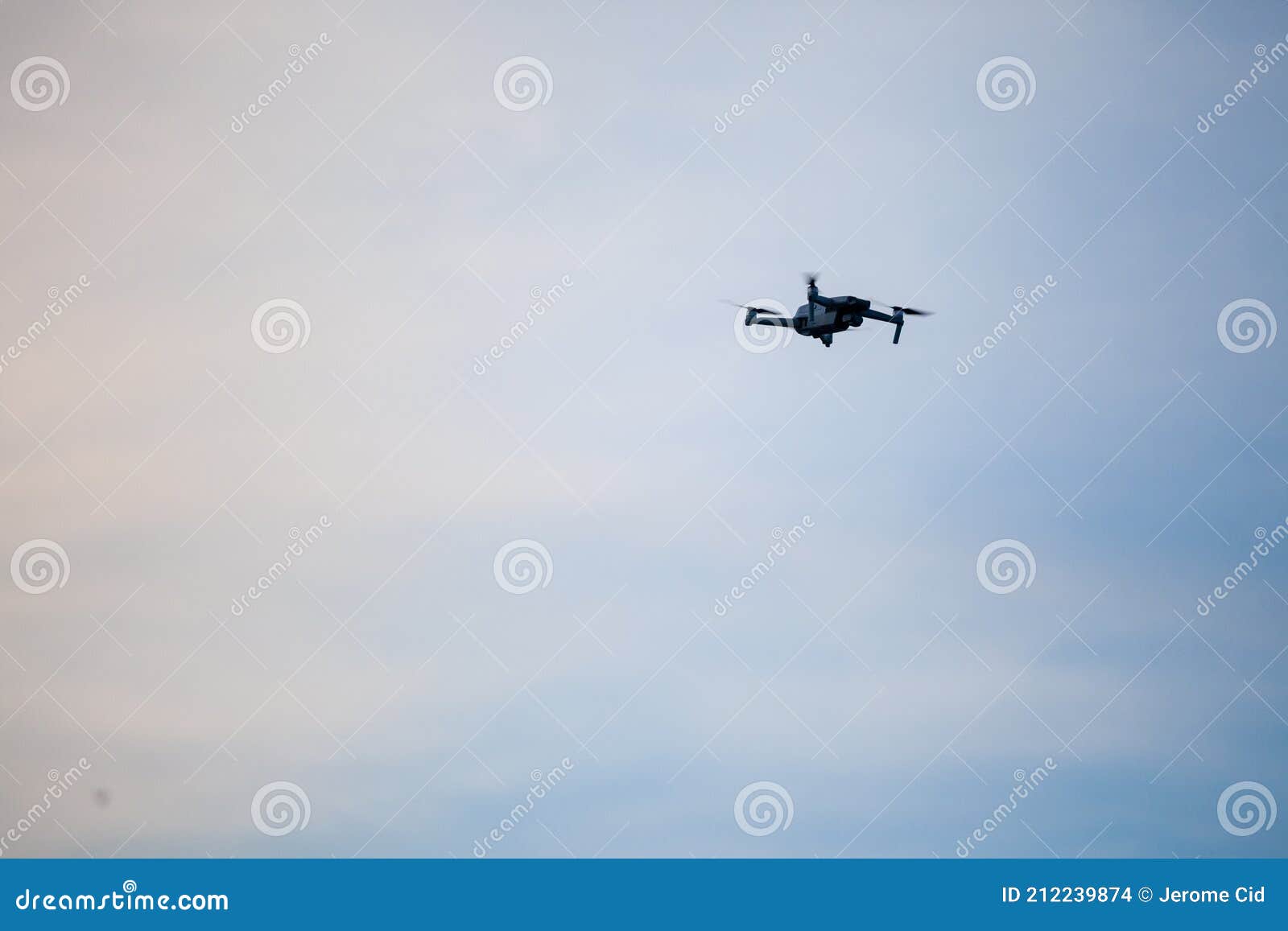 small unregistered consumer drone flying. these kind of small quadcoper drones don`t need license to be operated