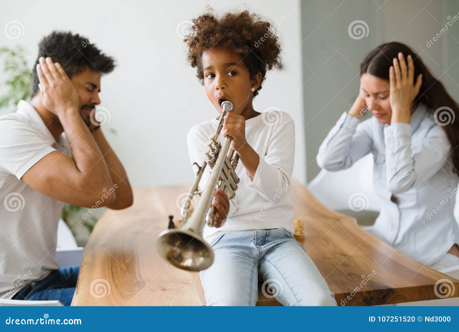picture of child making noise by playing trumpet