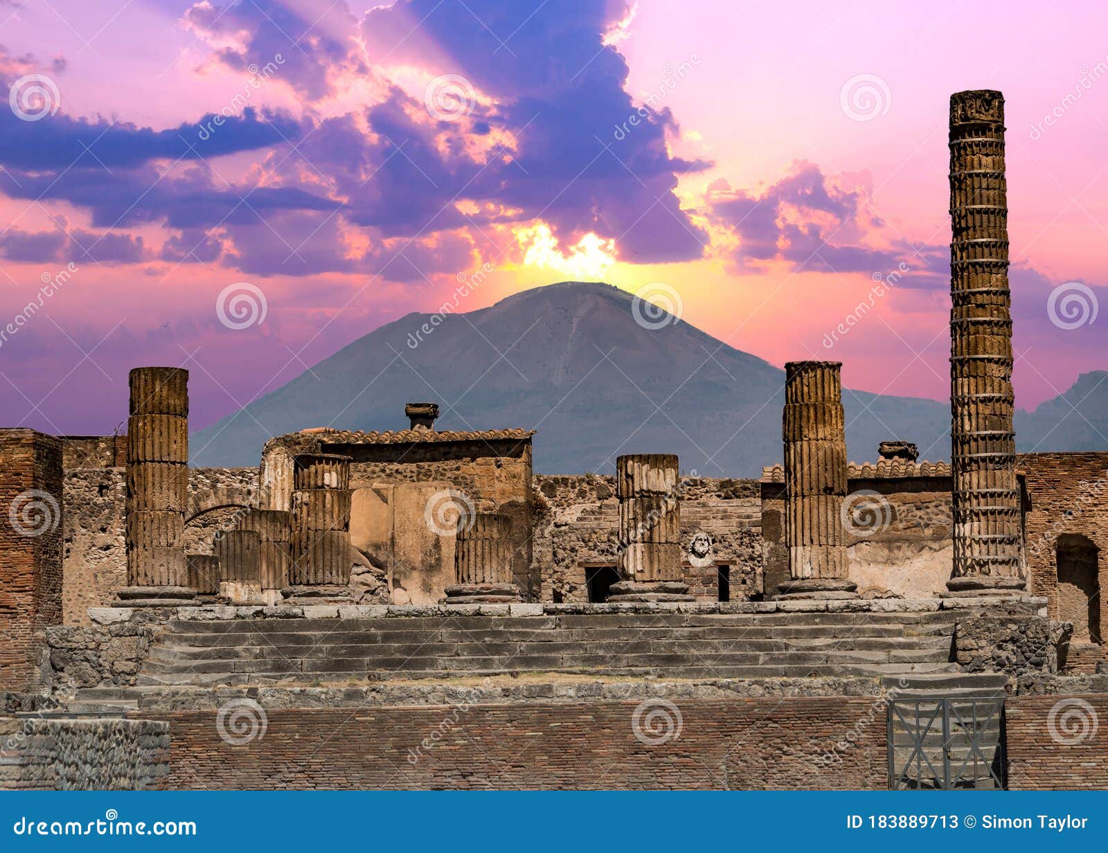 pompeii and mount vesuvius against a vibrant sunset