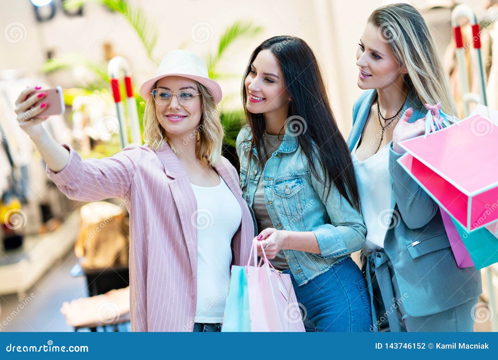 Picture of Group of Happy Friends Shopping for Clothes in Mall Stock ...