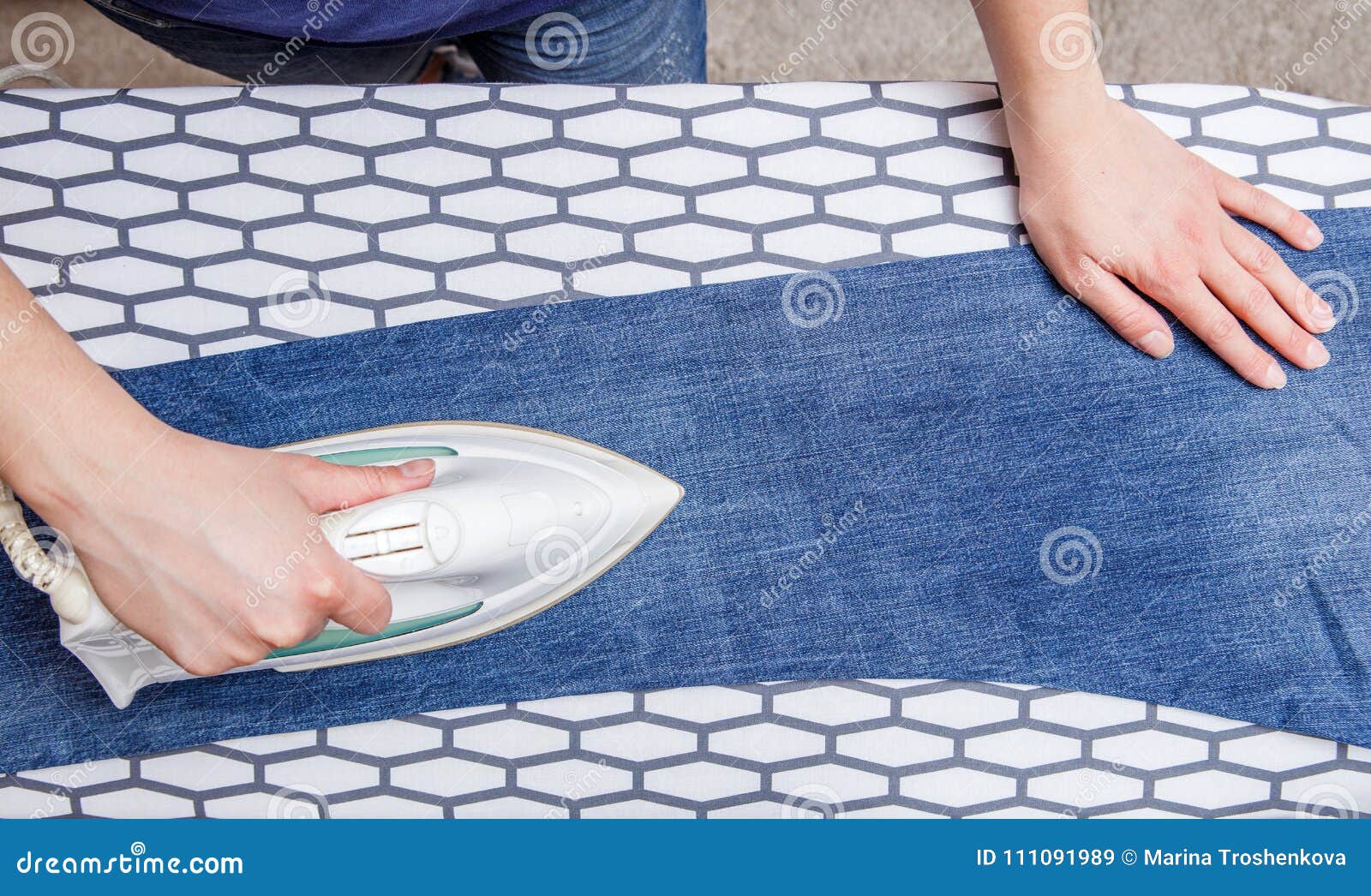 Picture of Man Ironing Blue Jeans on Board Stock Image Image of