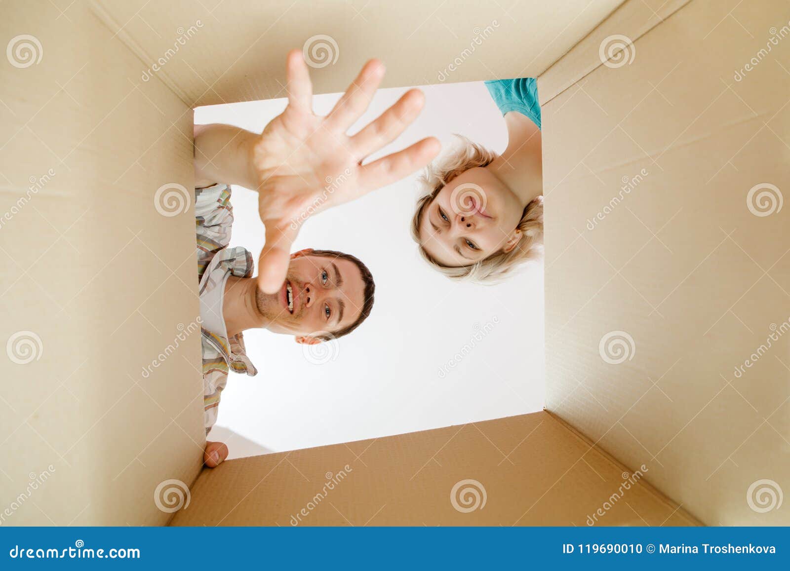 picture of man and woman peering into cardboard box