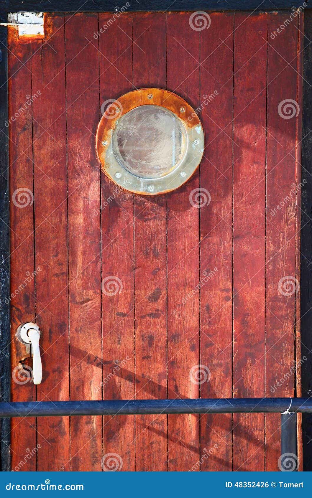 picture of old ship door with a round window stock photo