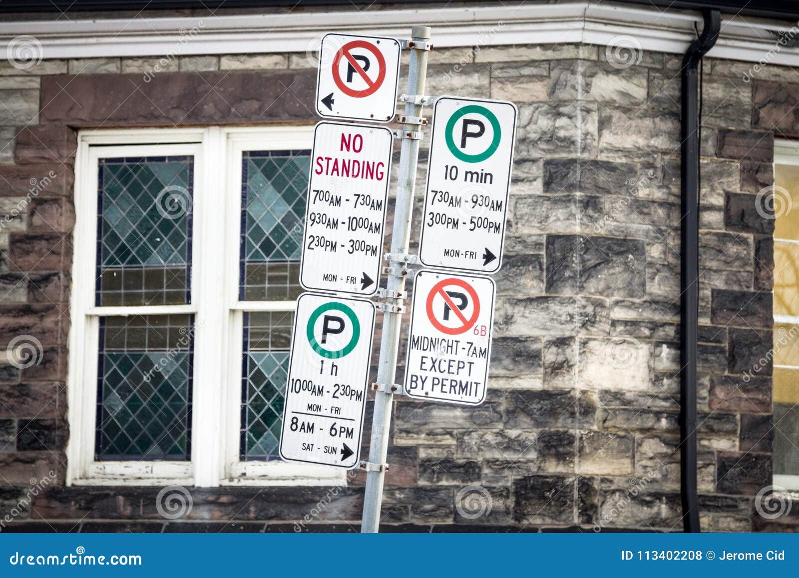 typical north american no parking signs with detailed instructions on the parking regulations taken in toronto, ontario, canada