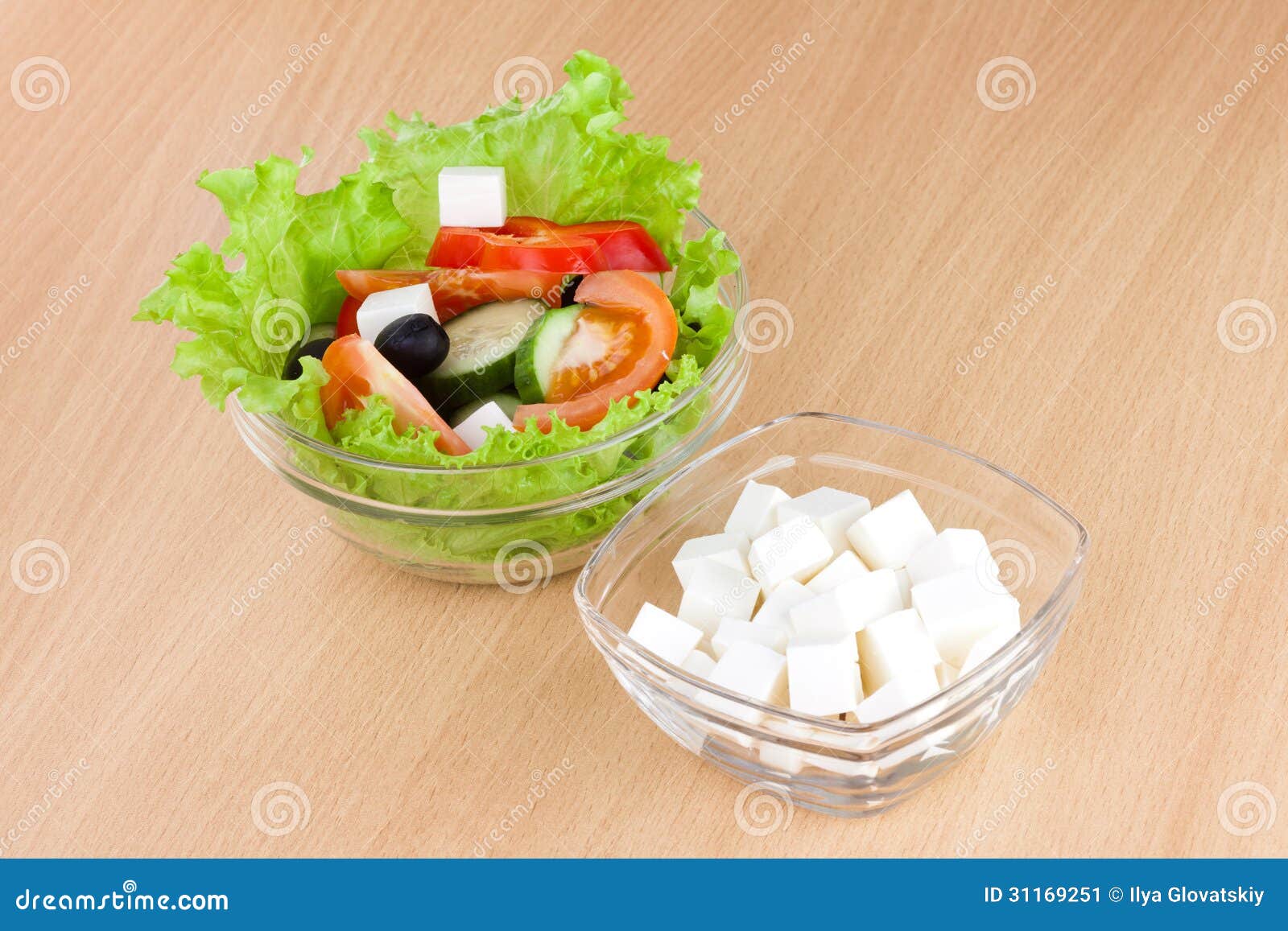 Picture of plates with greek salad and feta on table