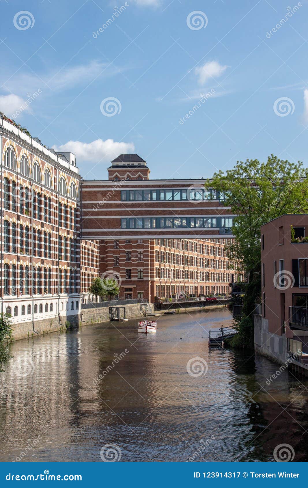 picture from the river elster in the scene district leipzig schleussig with beautiful lofts in old industrie buildings