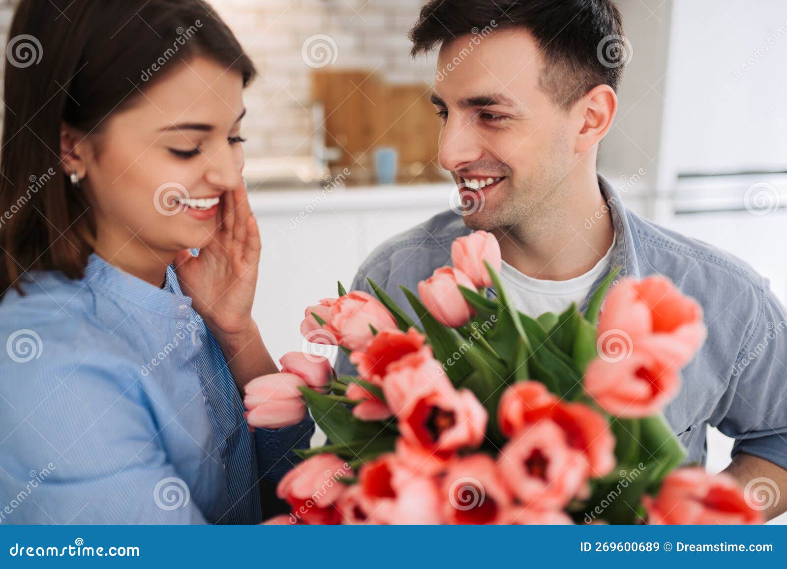 picture showing man giving flowers to a woman at home. romantic concept. woman`s day