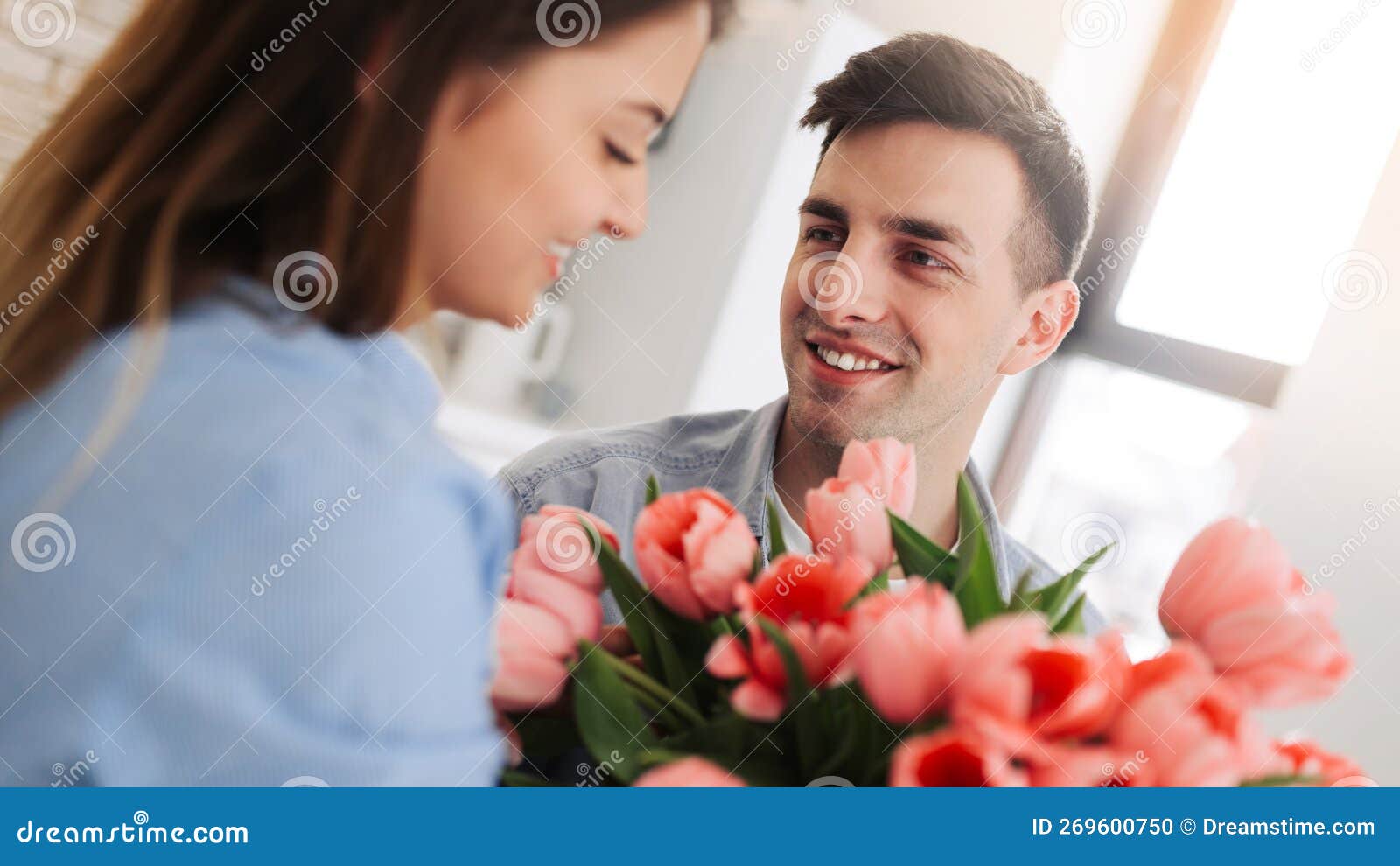 picture showing man giving flowers to a woman at home. romantic concept. woman`s day
