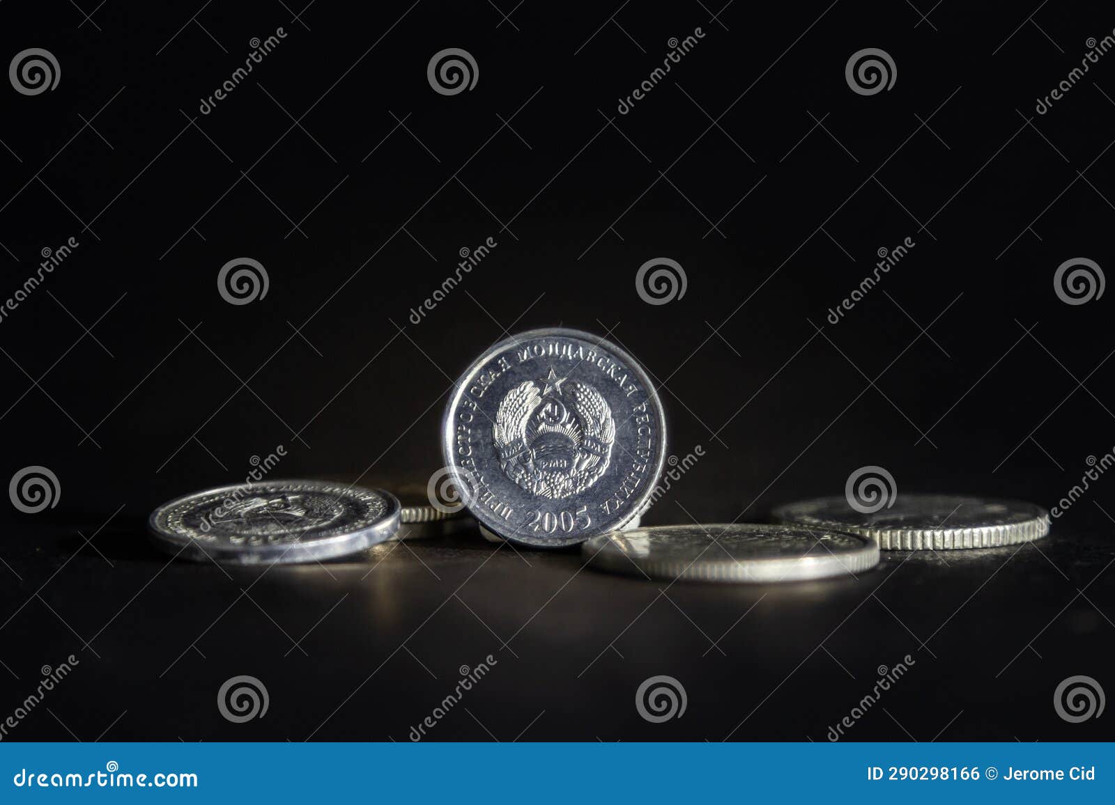 selective blur on coins of transnistrian rubles with the soviet coat of arms of transnistria with soviet hammer and sickle. it is