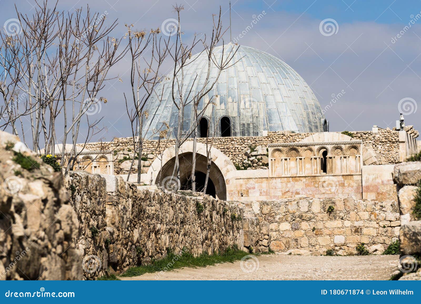 ummayad palace, walls and trees in the foreground