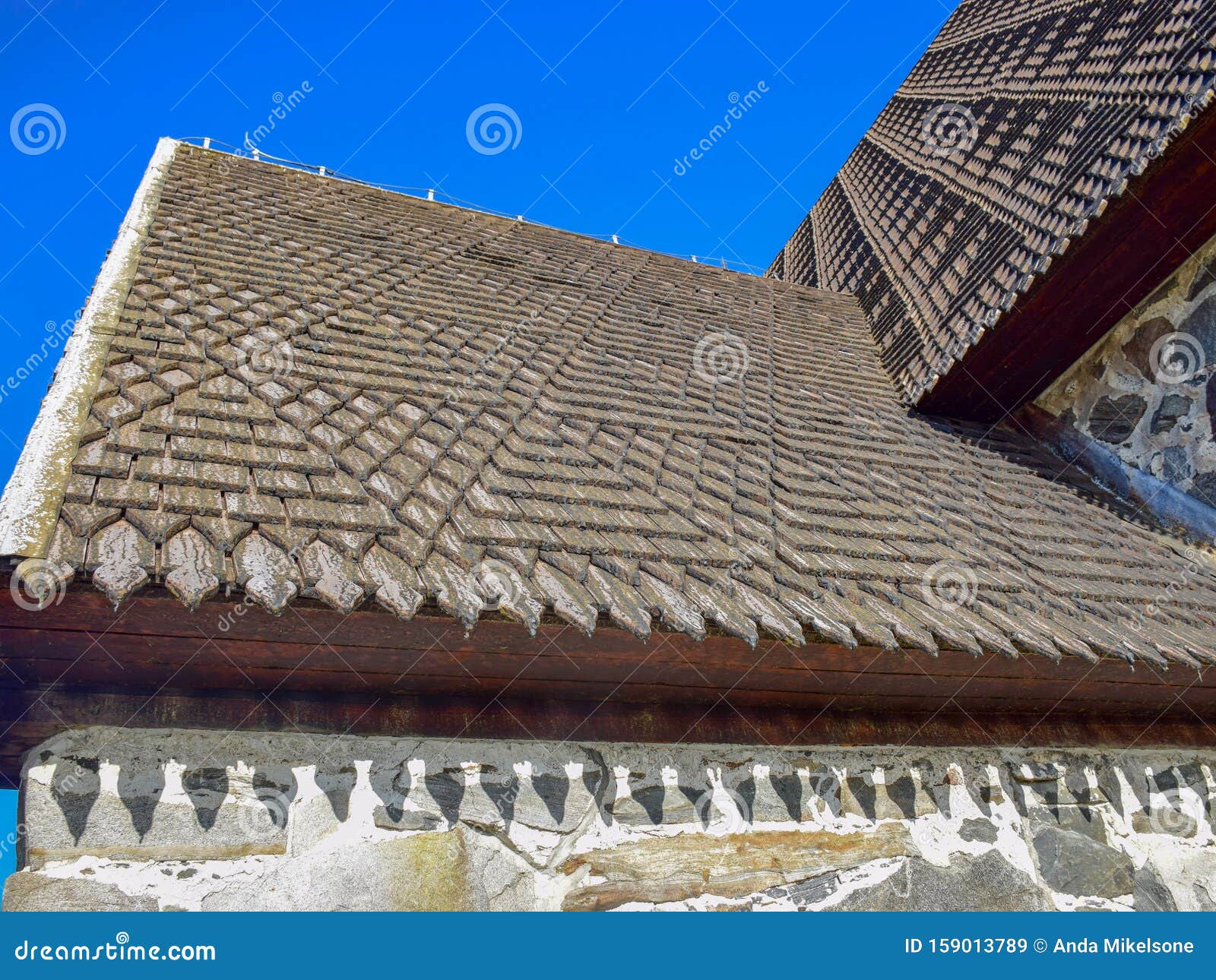 picture of a very old stone house, fragments of wooden tile roof