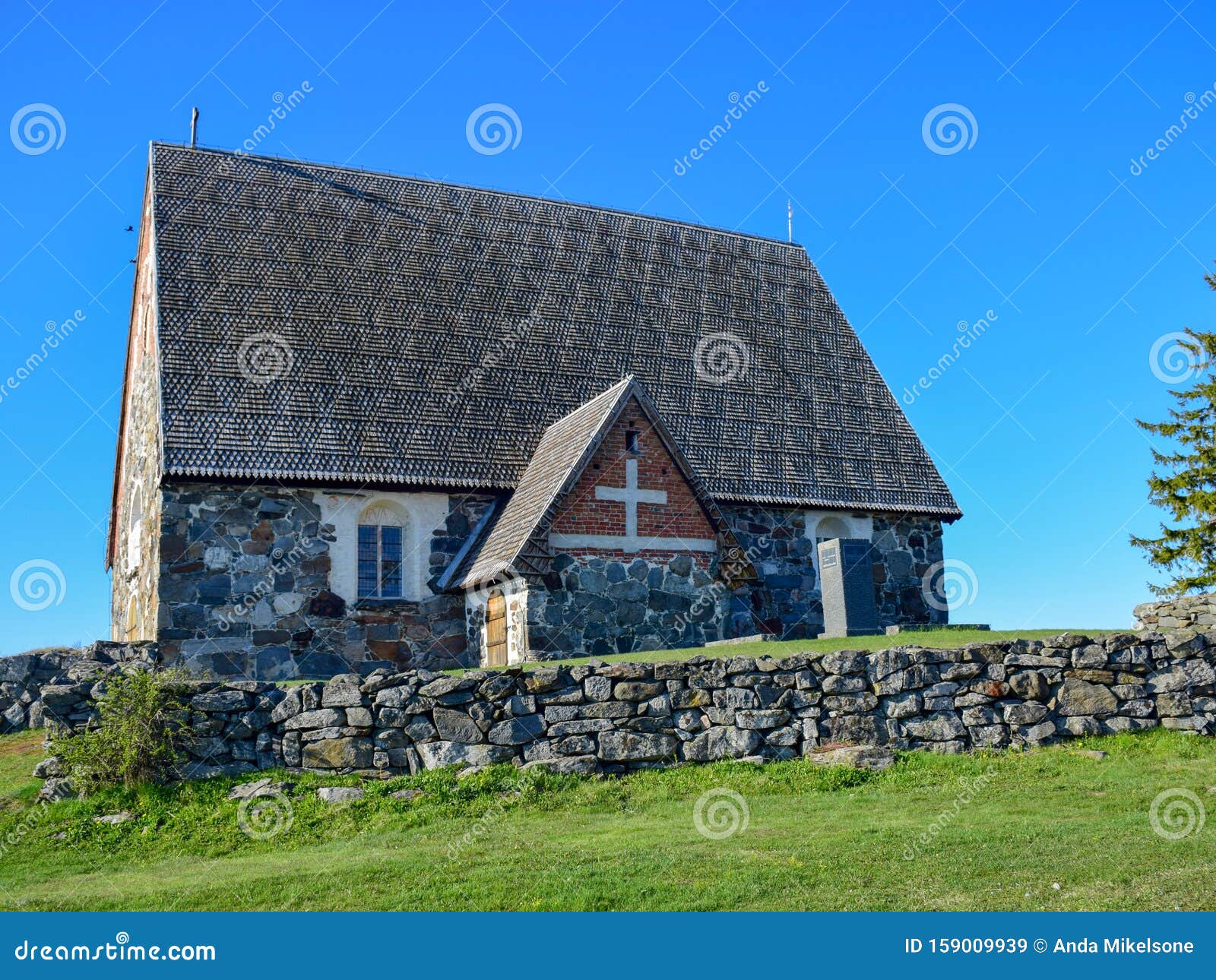 picture with very old stone house, interesting wooden tile roof