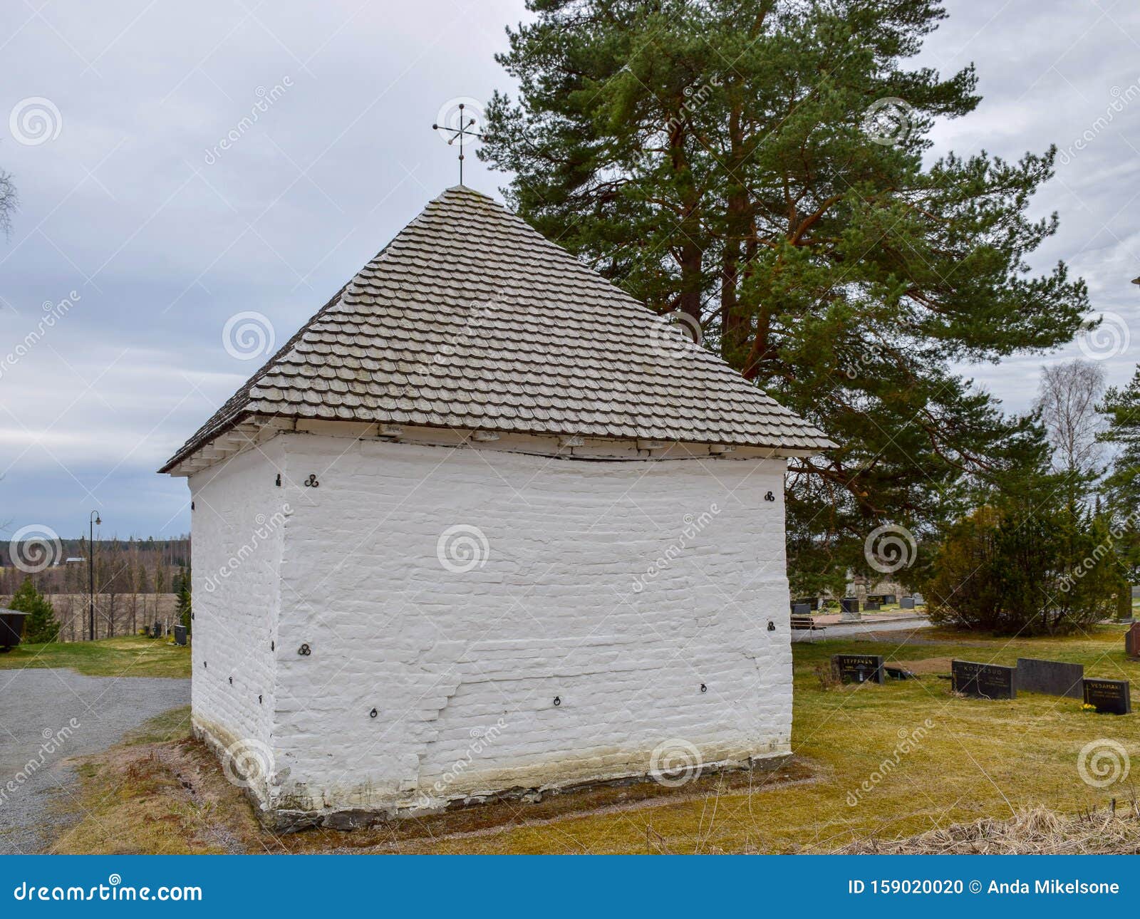 picture with very old stone house, interesting wooden tile roof
