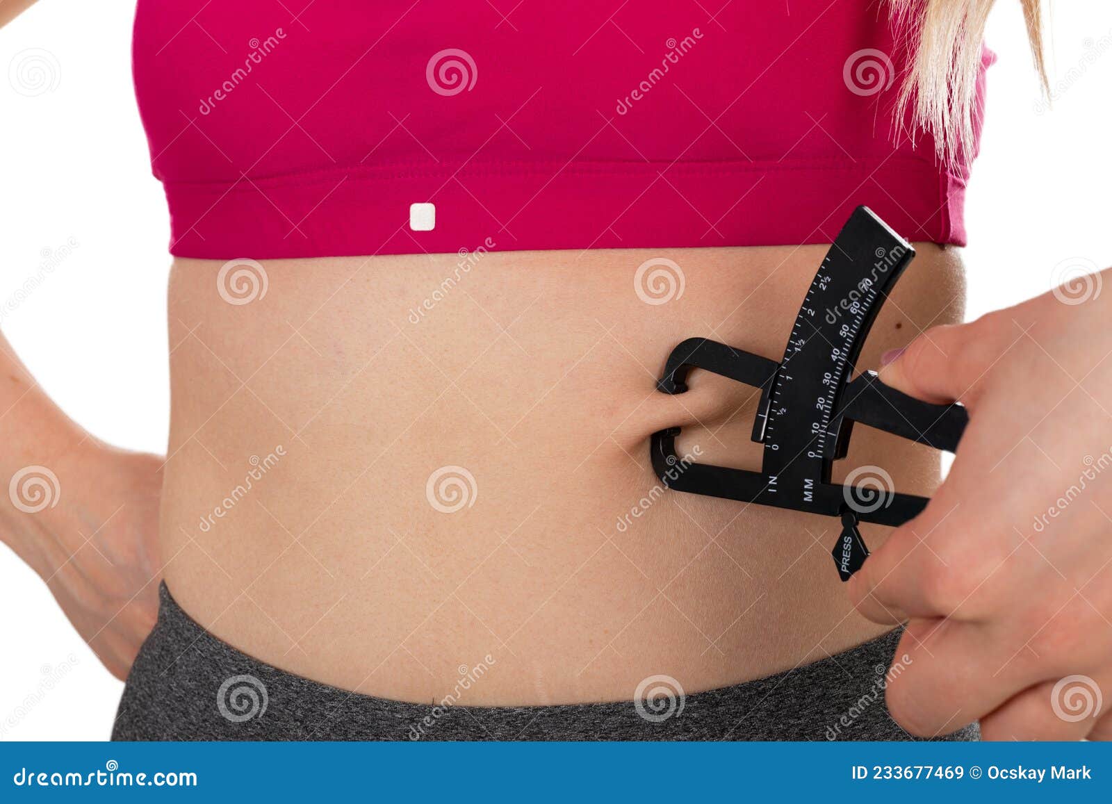 Body fat calipers, woman measuring subcutaneous percentage of fat