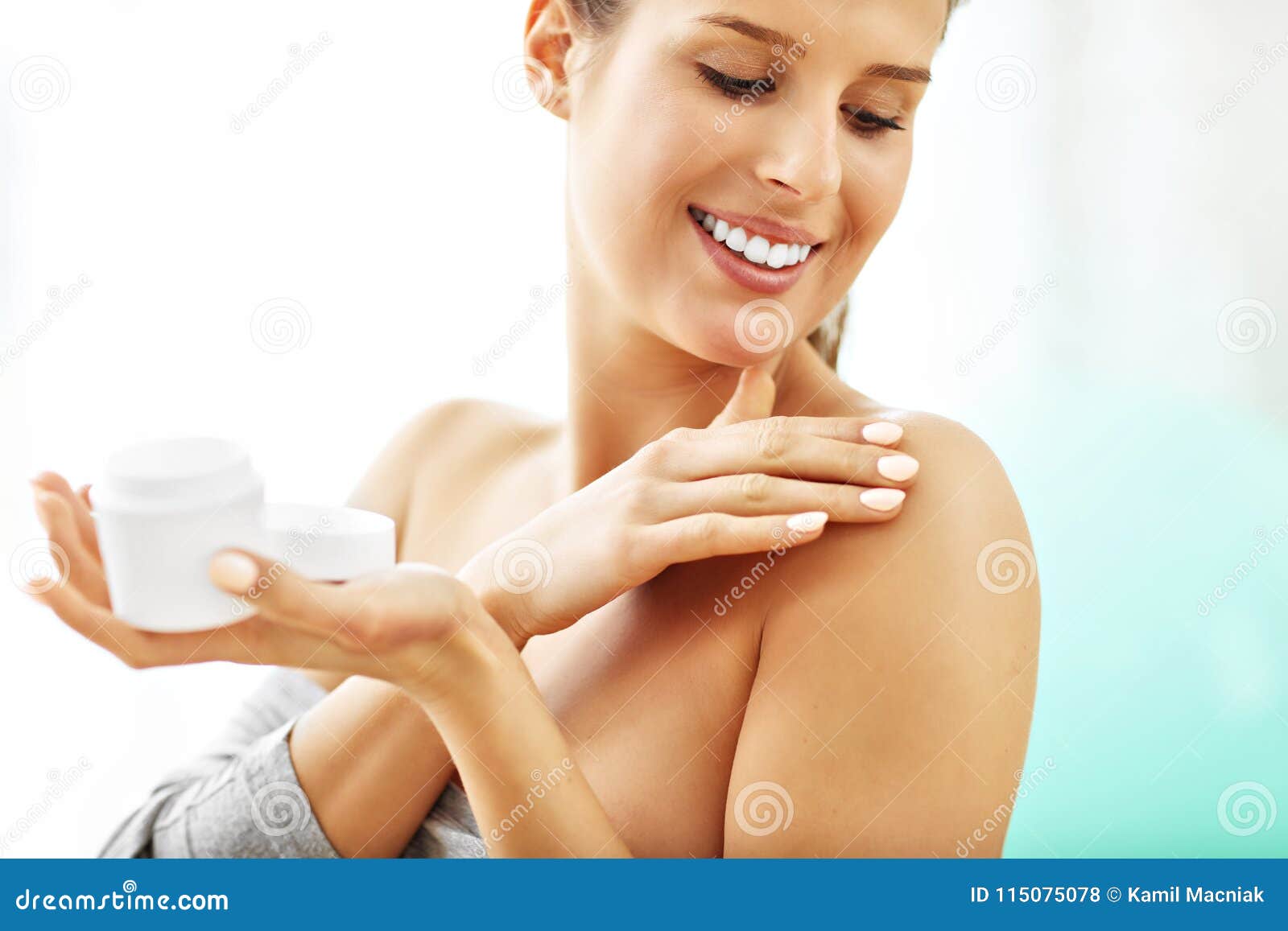 woman using body lotion on her skin