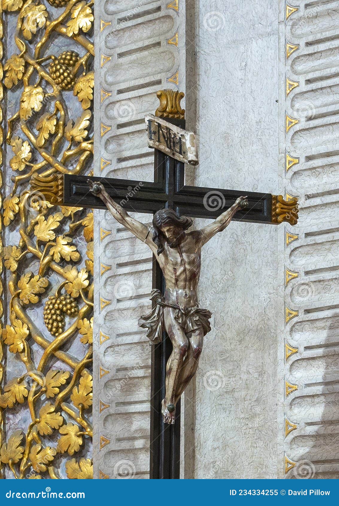 statue of jesus nailed to the cross inside the sanctuary of our lady of nazare, portugal.