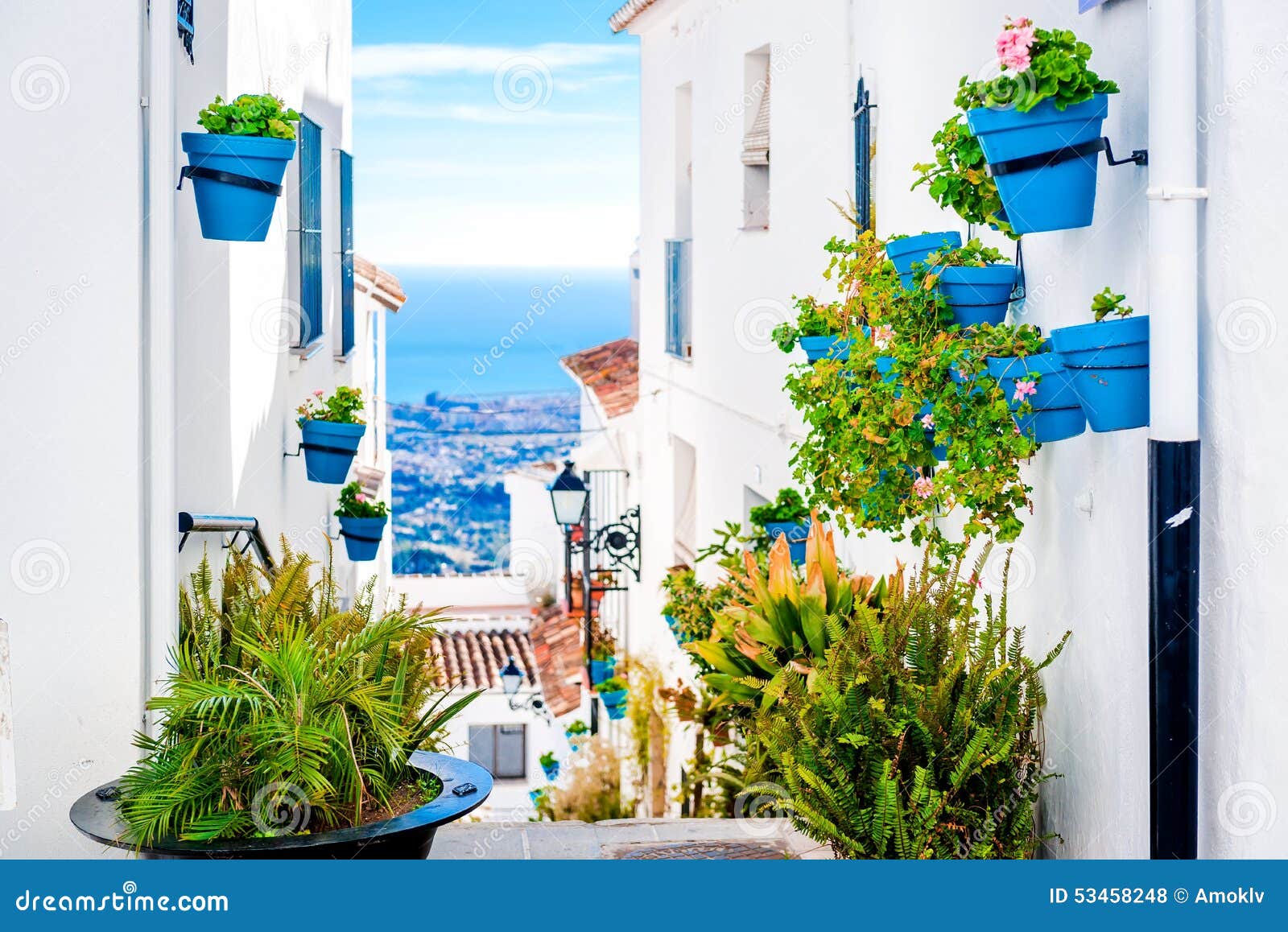 picturesque street of mijas with flower pots in facades