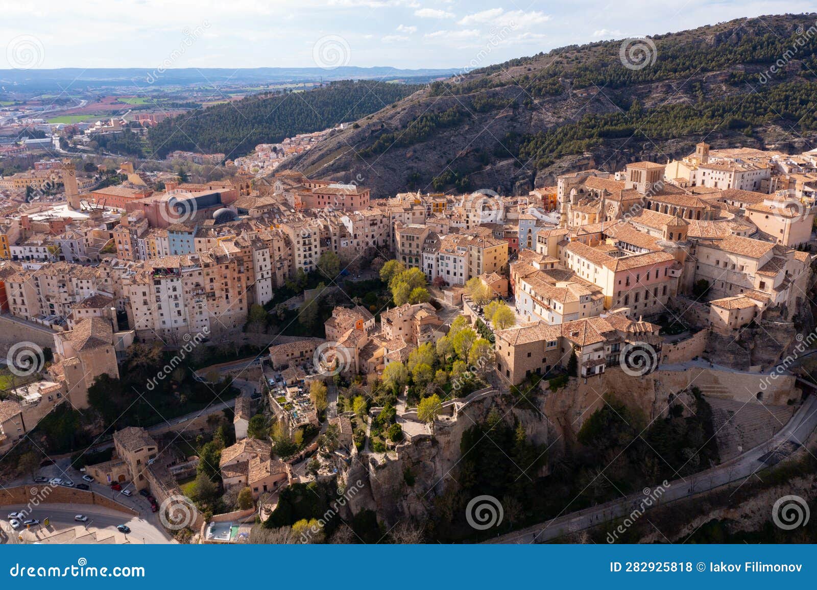 drone view of cuenca city on spur above gorge on spring day