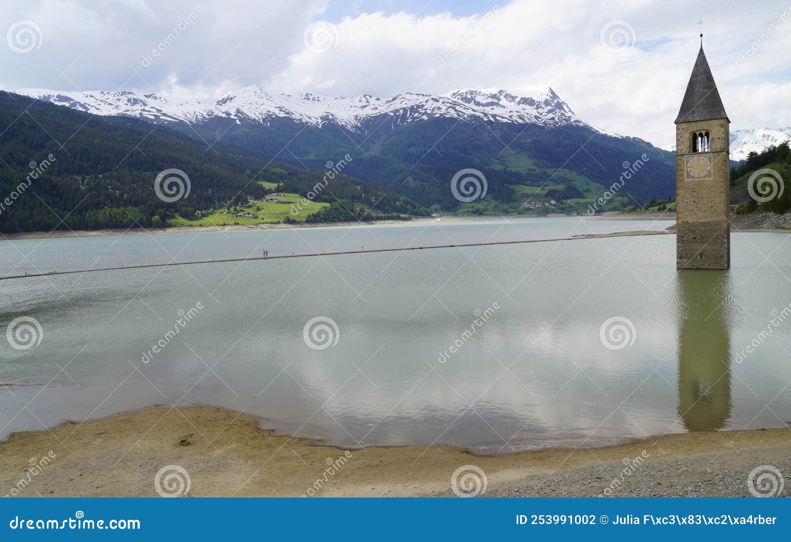 scenic view of lake resia and sunken church steeple of lago di resia in curon region (vinschgau, south tyrol, italy)