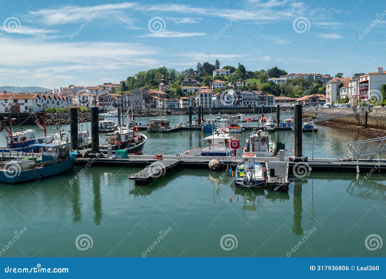 port of saint jean de luz with some boats anchored with part of the city in the background