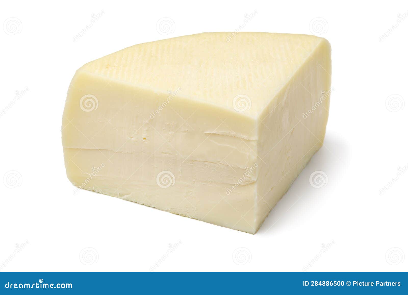 piece of artisanal of semi soft italian bel paese cheese on white background close up