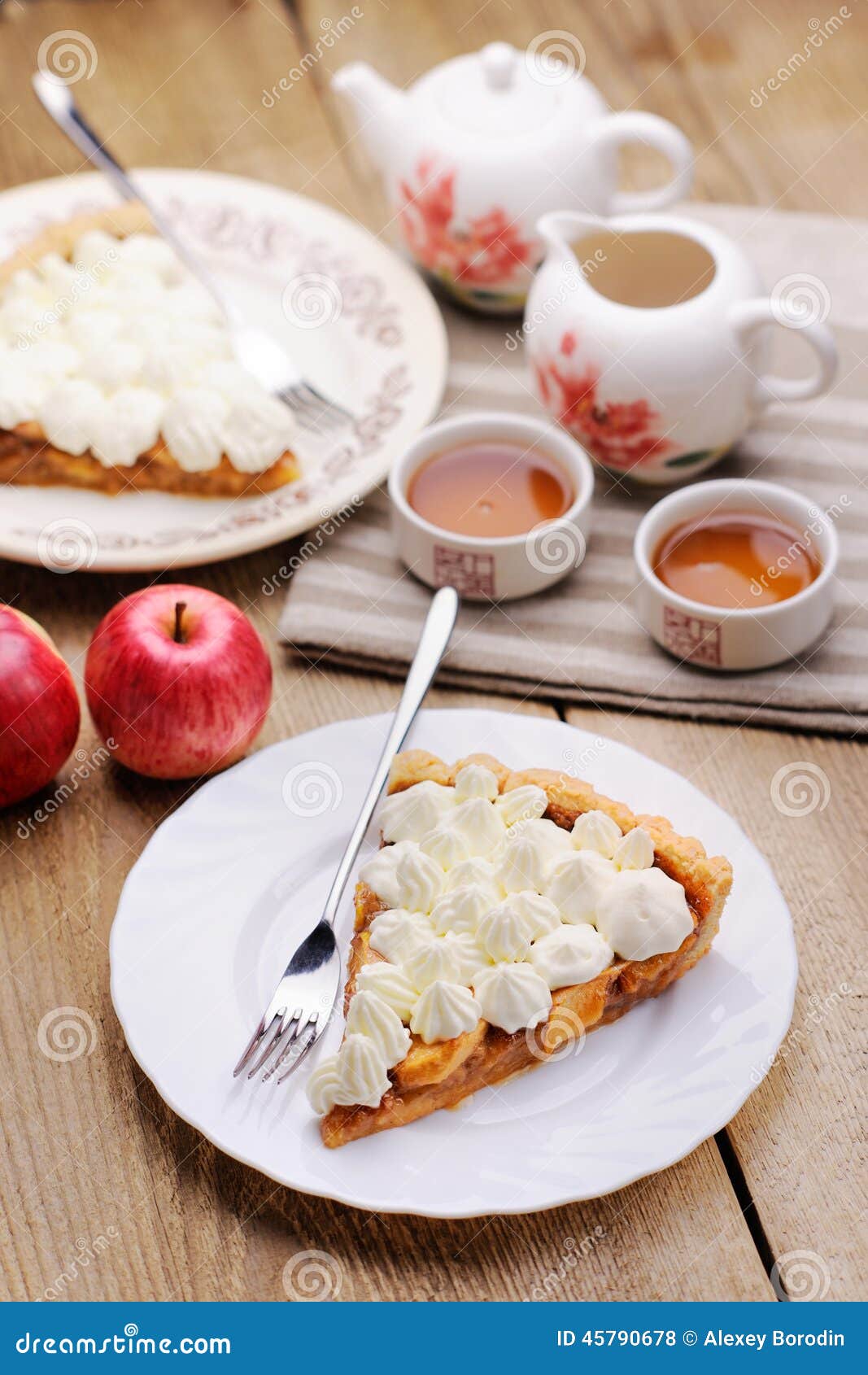 Piece of Cake Decorated with Whipped Cream with Teaware and Apples T ...