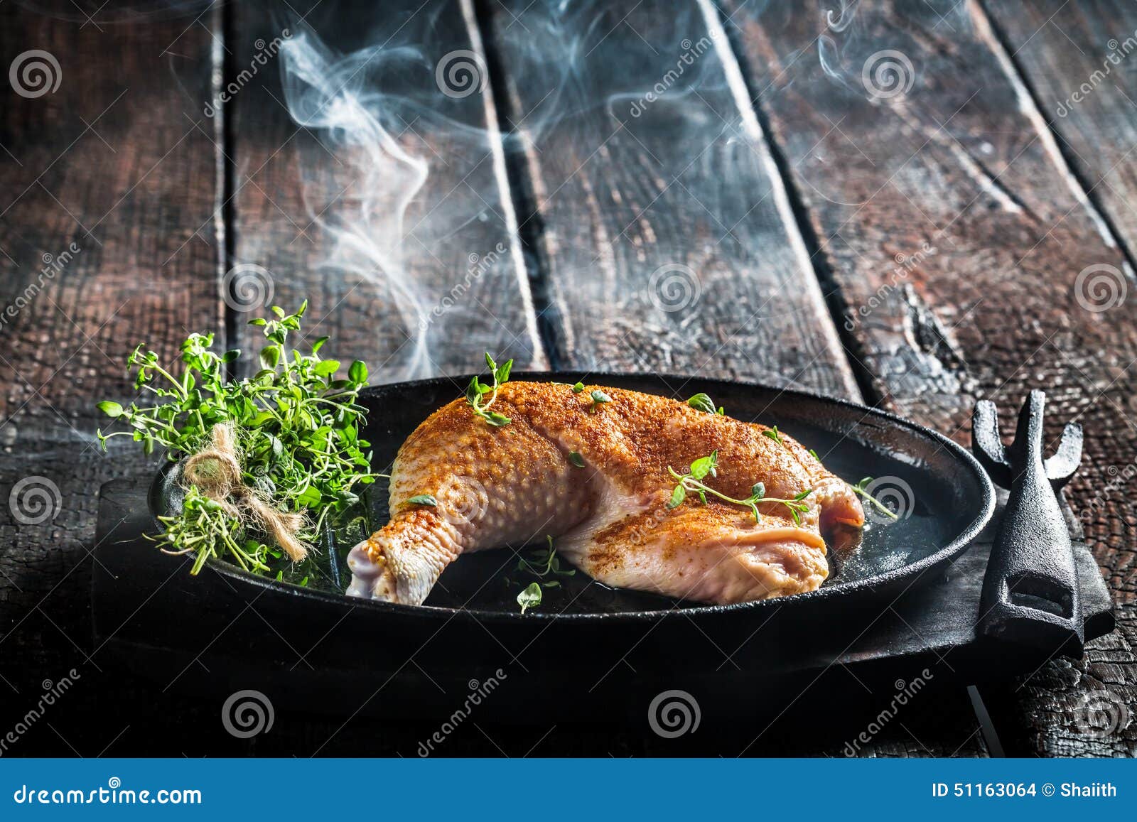 Piece of Chicken with Fresh Marjoram Ready for Grilling Stock Photo