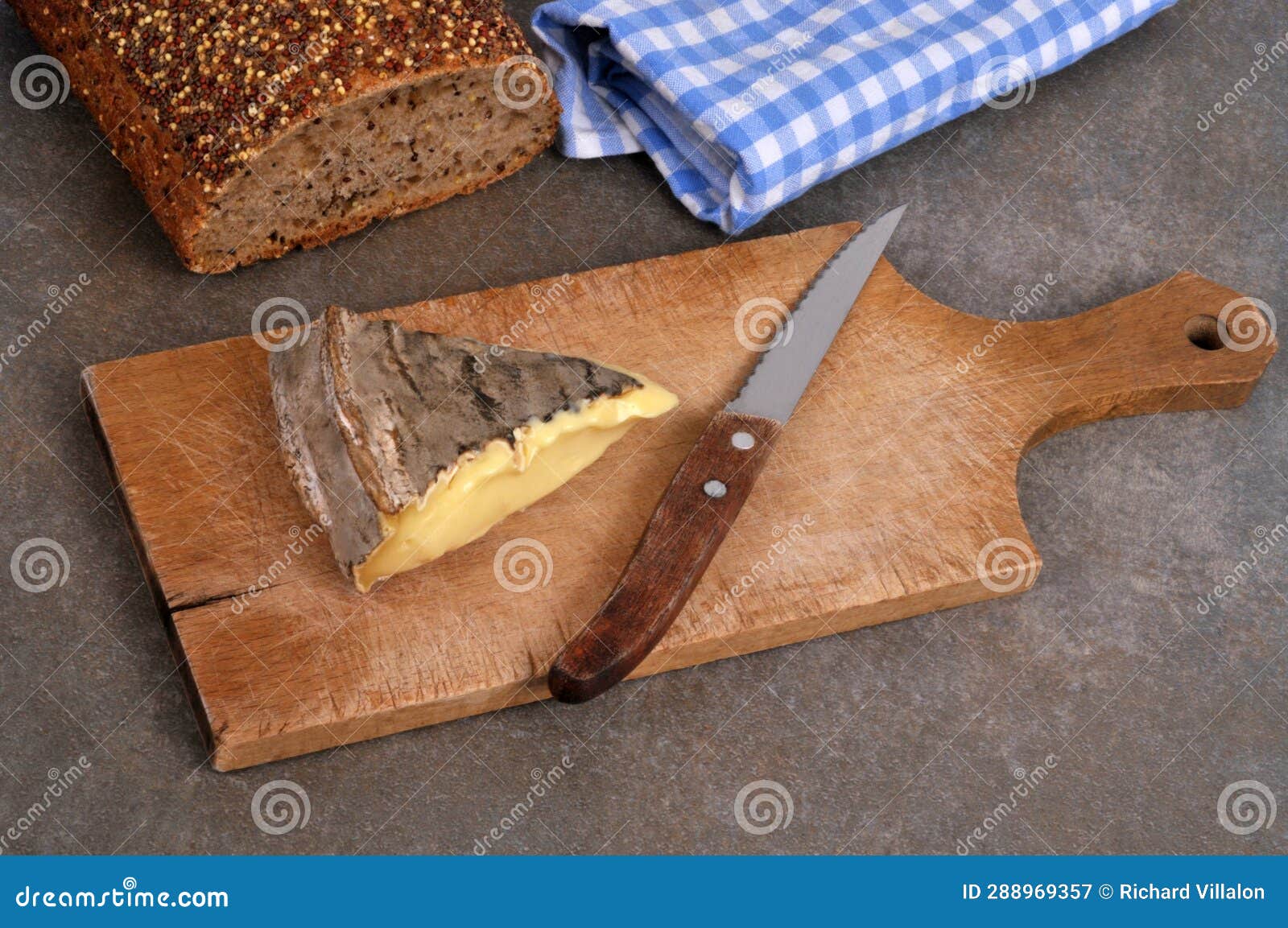 french saint-nectaire cheese on kitchen utensil