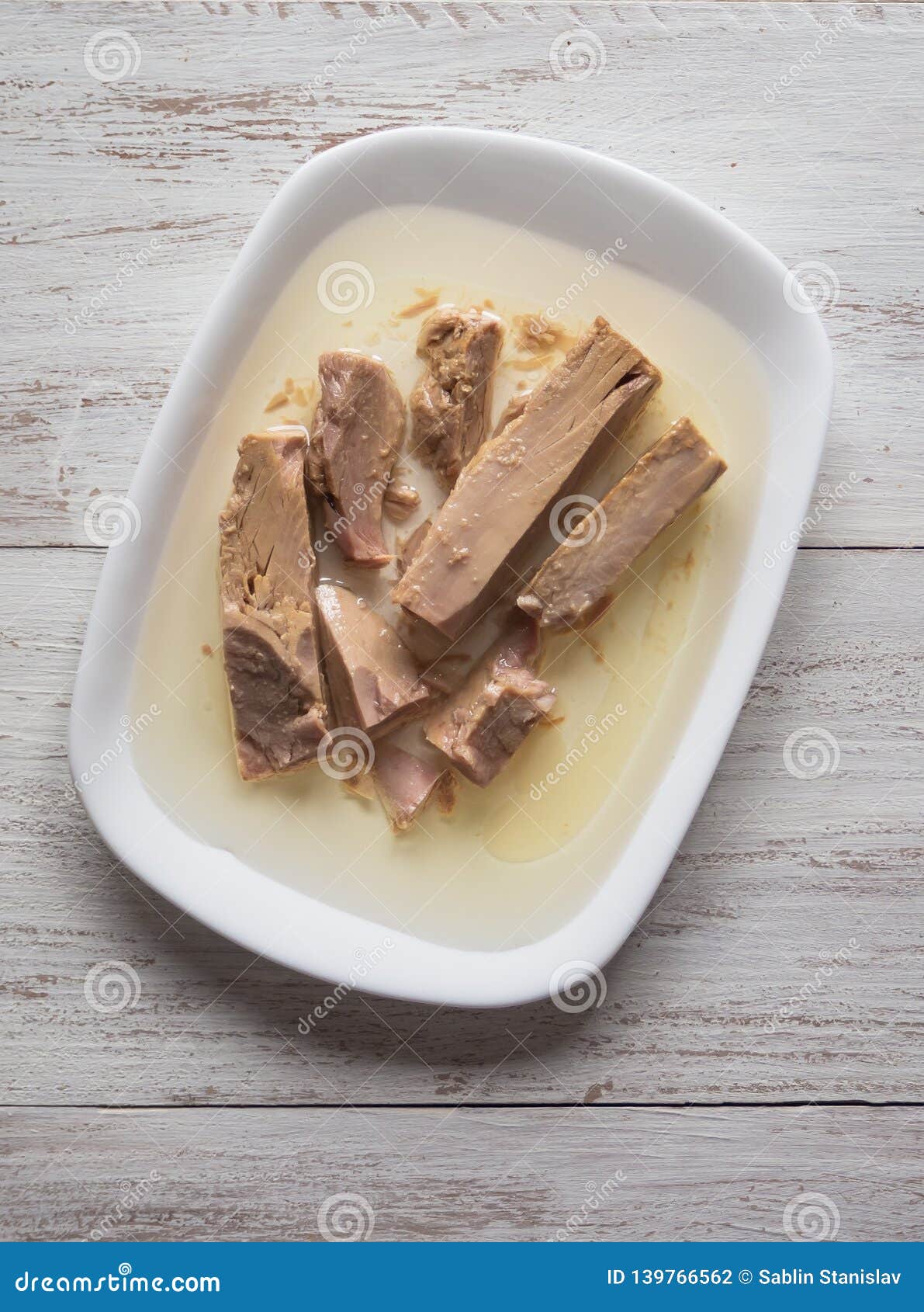 Pieces of Canned Tuna in Olive Oil on a Plate. Stock Photo Image of