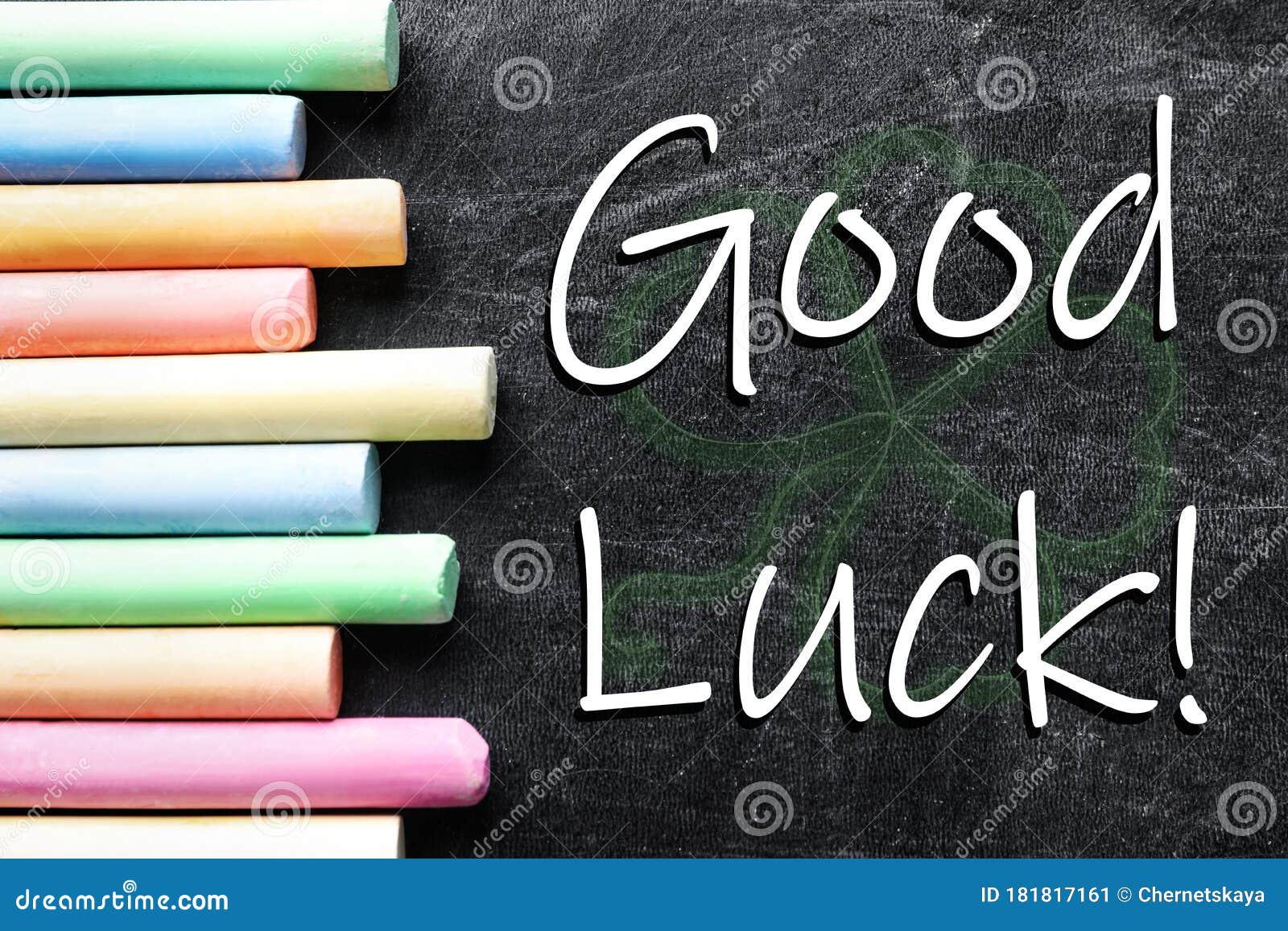 Pieces of Color Chalk and Phrase GOOD LUCK on Blackboard Stock Image