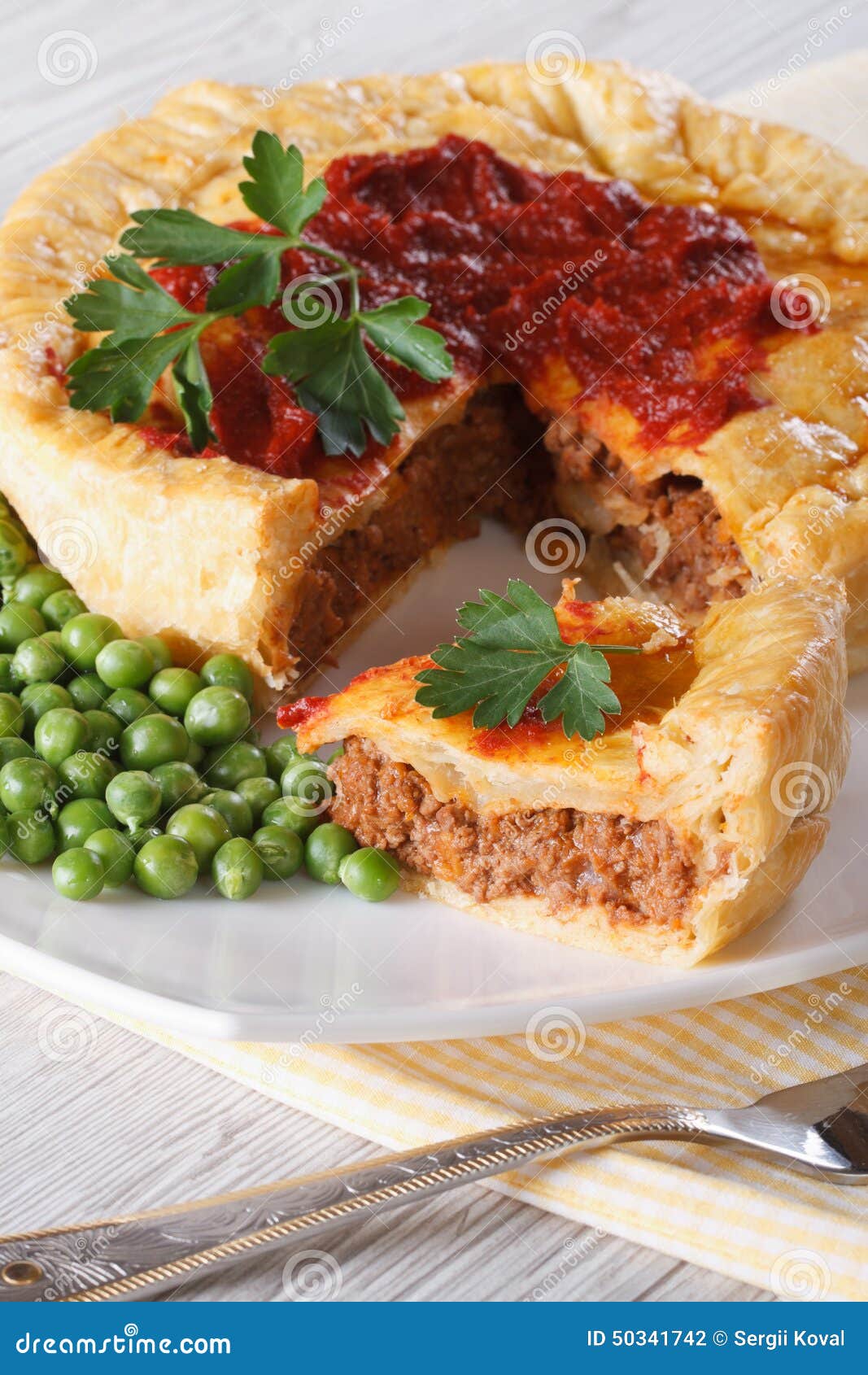 Pieces of Meat Pie and a Garnish of Green Peas. Vertical Stock Photo ...